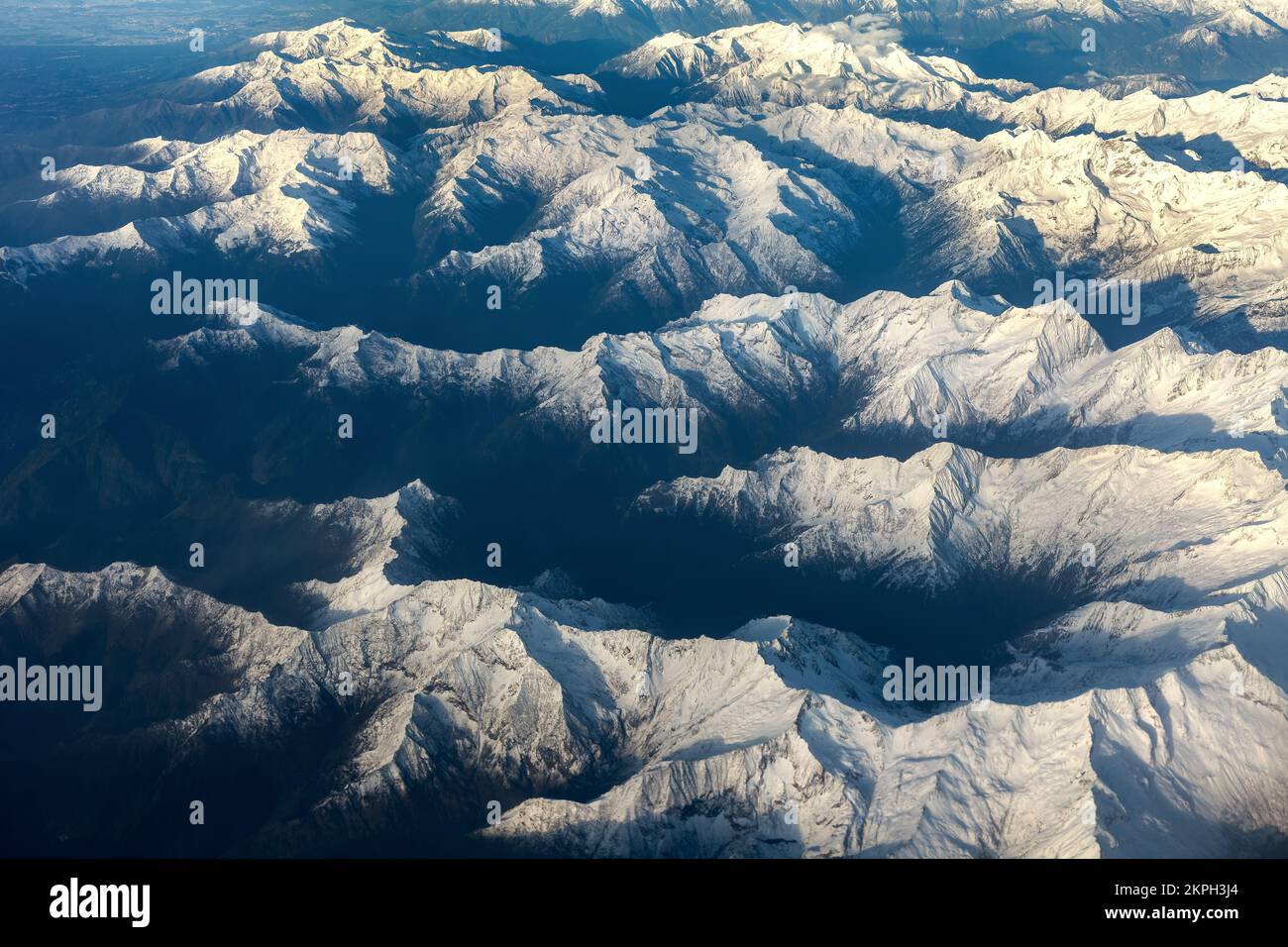 Aerial view of the mountains covered with snow. Stock Photo