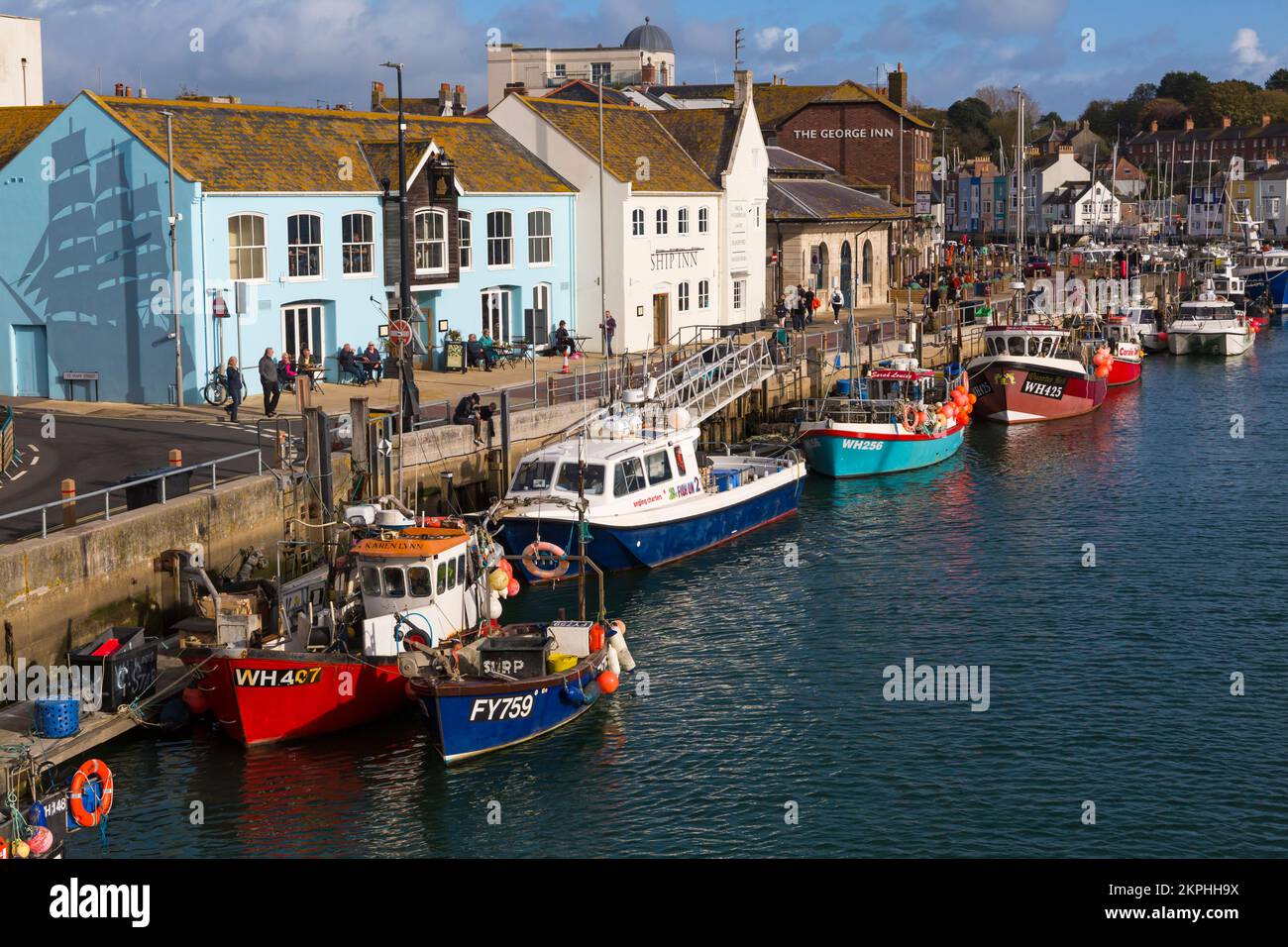 Boats moored along harbourside at Weymouth harbour, Weymouth quay at Weymouth, Dorset UK in October Stock Photo