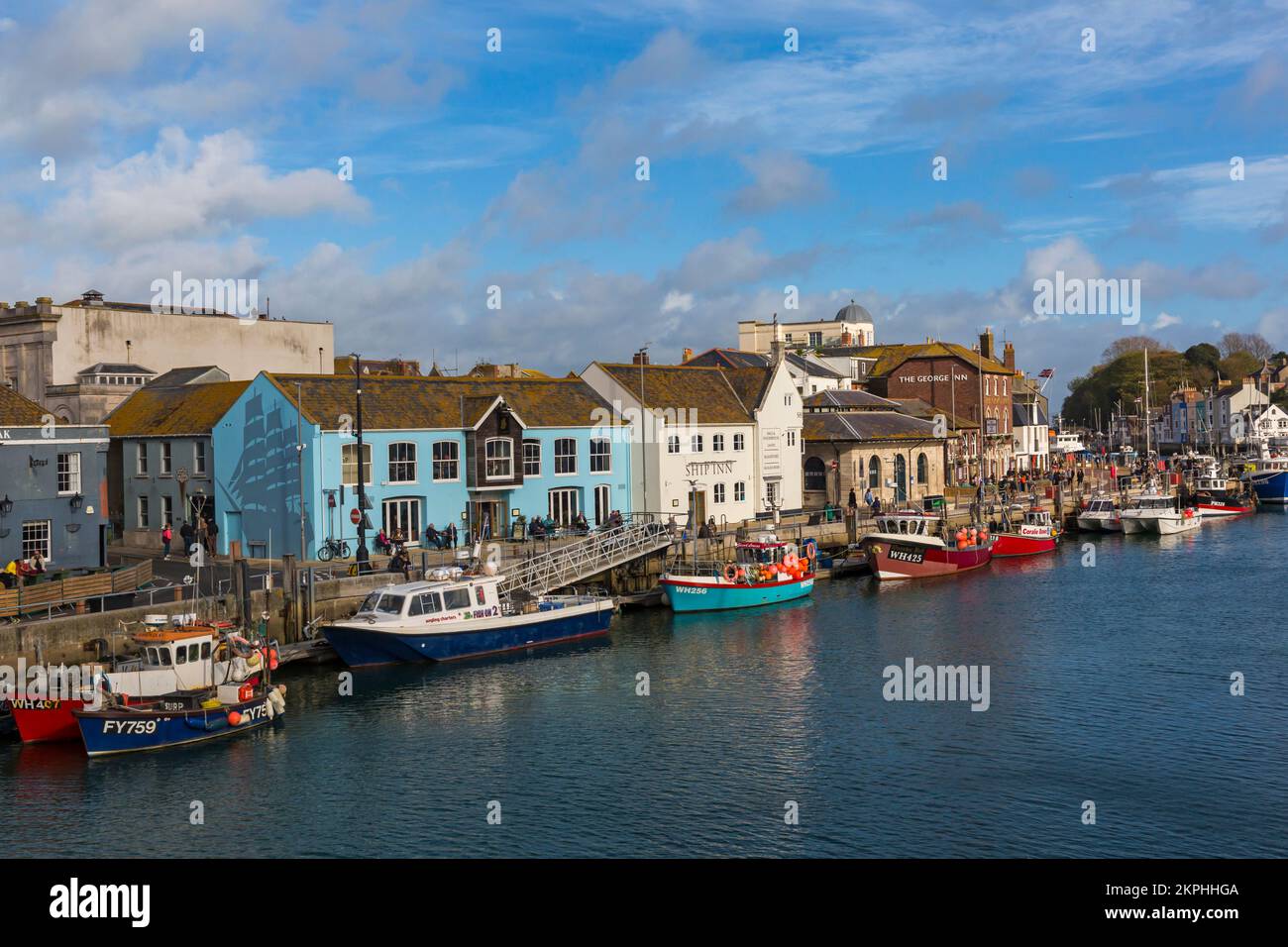 Boats moored along harbourside at Weymouth harbour, Weymouth quay at Weymouth, Dorset UK in October Stock Photo