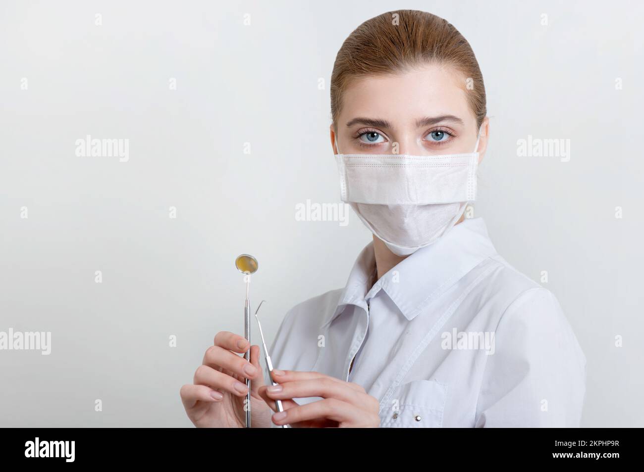Young dentist doctor with dental instruments. Studio shoot. Stock Photo