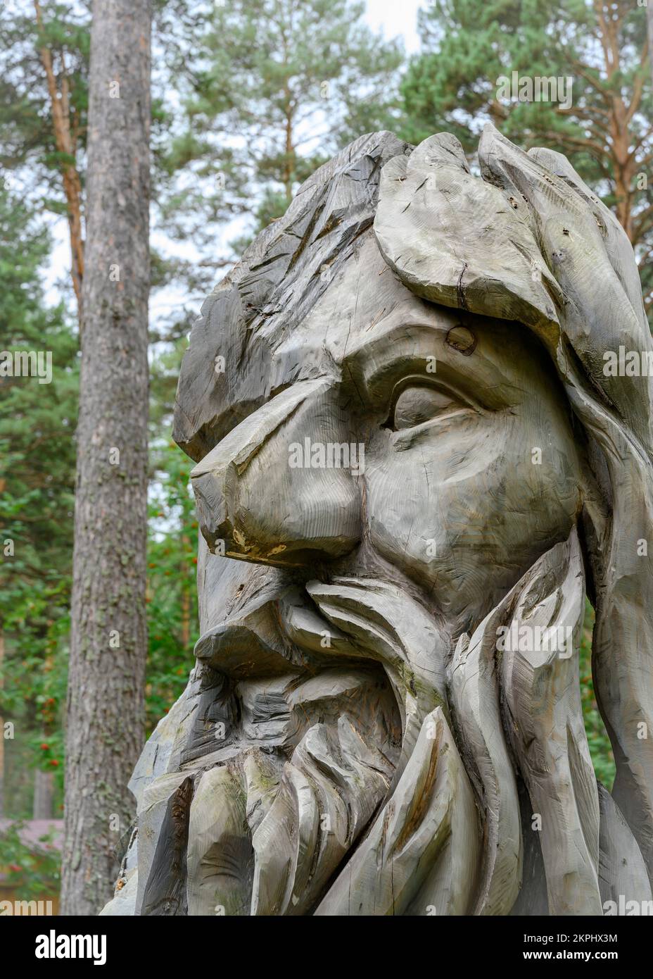 A fragment of a wooden sculpture of a forest deity in the Siberian forest Stock Photo
