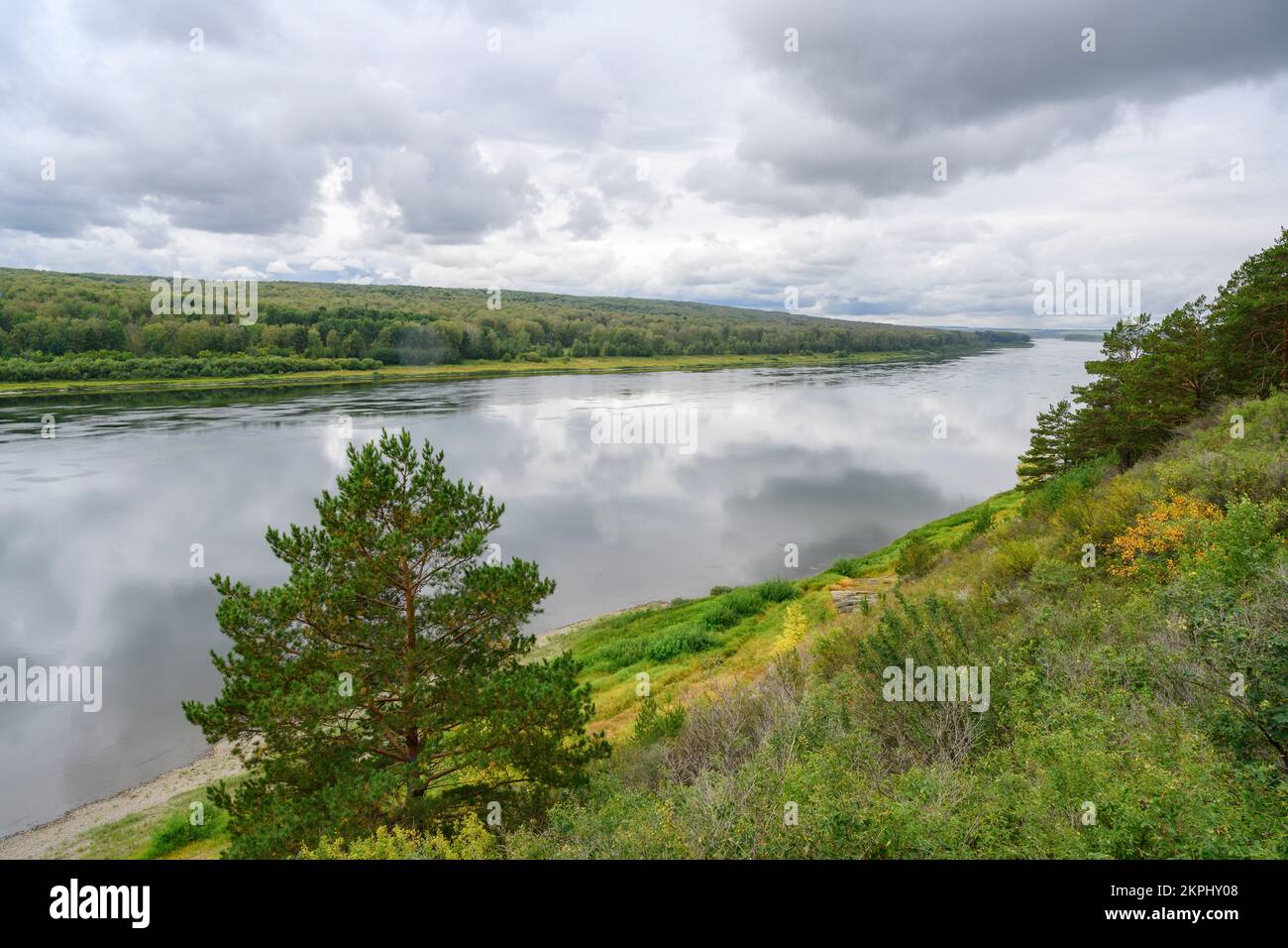 View of the Tom River in the Siberian taiga under a stormy sky in summer Stock Photo