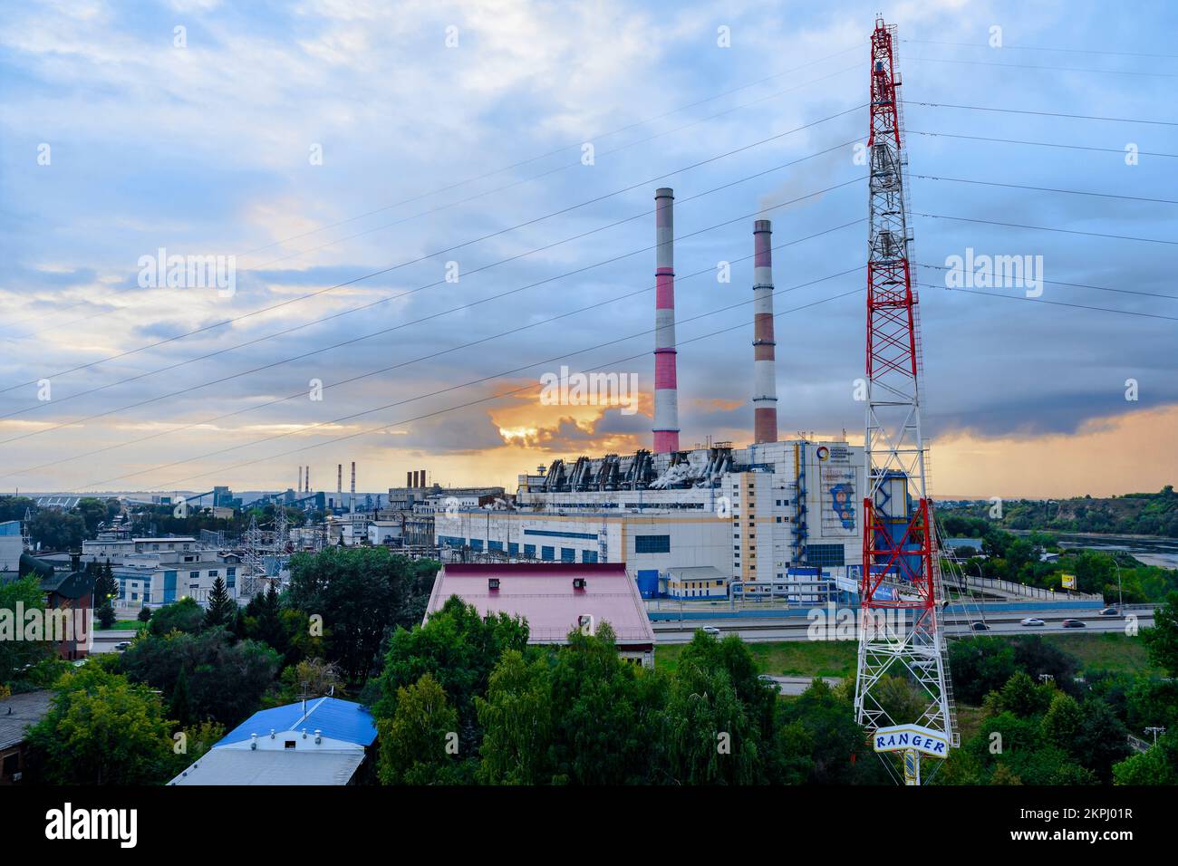 Sunset over the thermal power plant of the Siberian Generating Company (as it is written on the building) in the city of Kemerovo Stock Photo