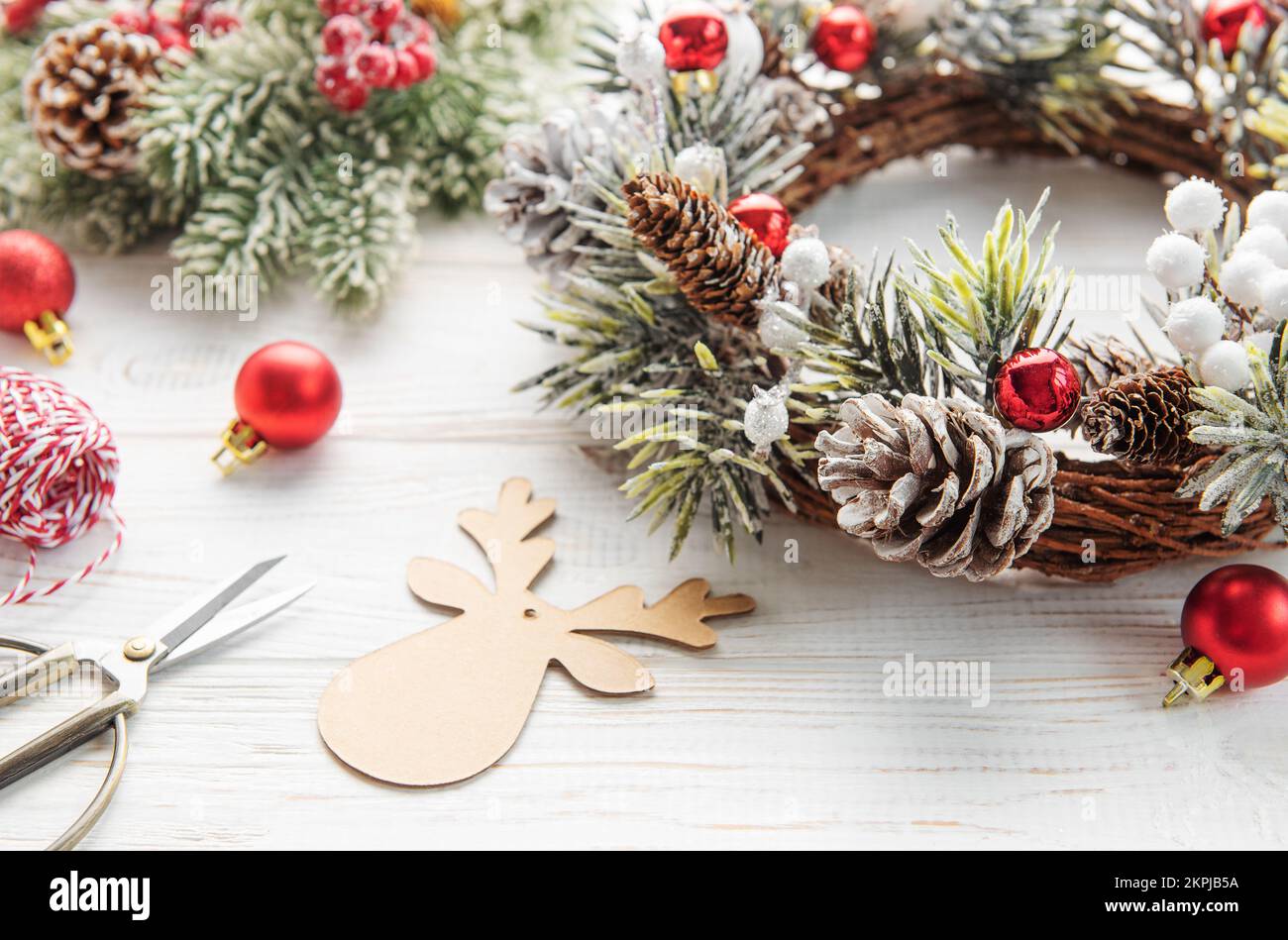 Decorative festive Christmas wreath. Wreath made of fir tree and cones on a old wooden background. Christmas decorations Stock Photo
