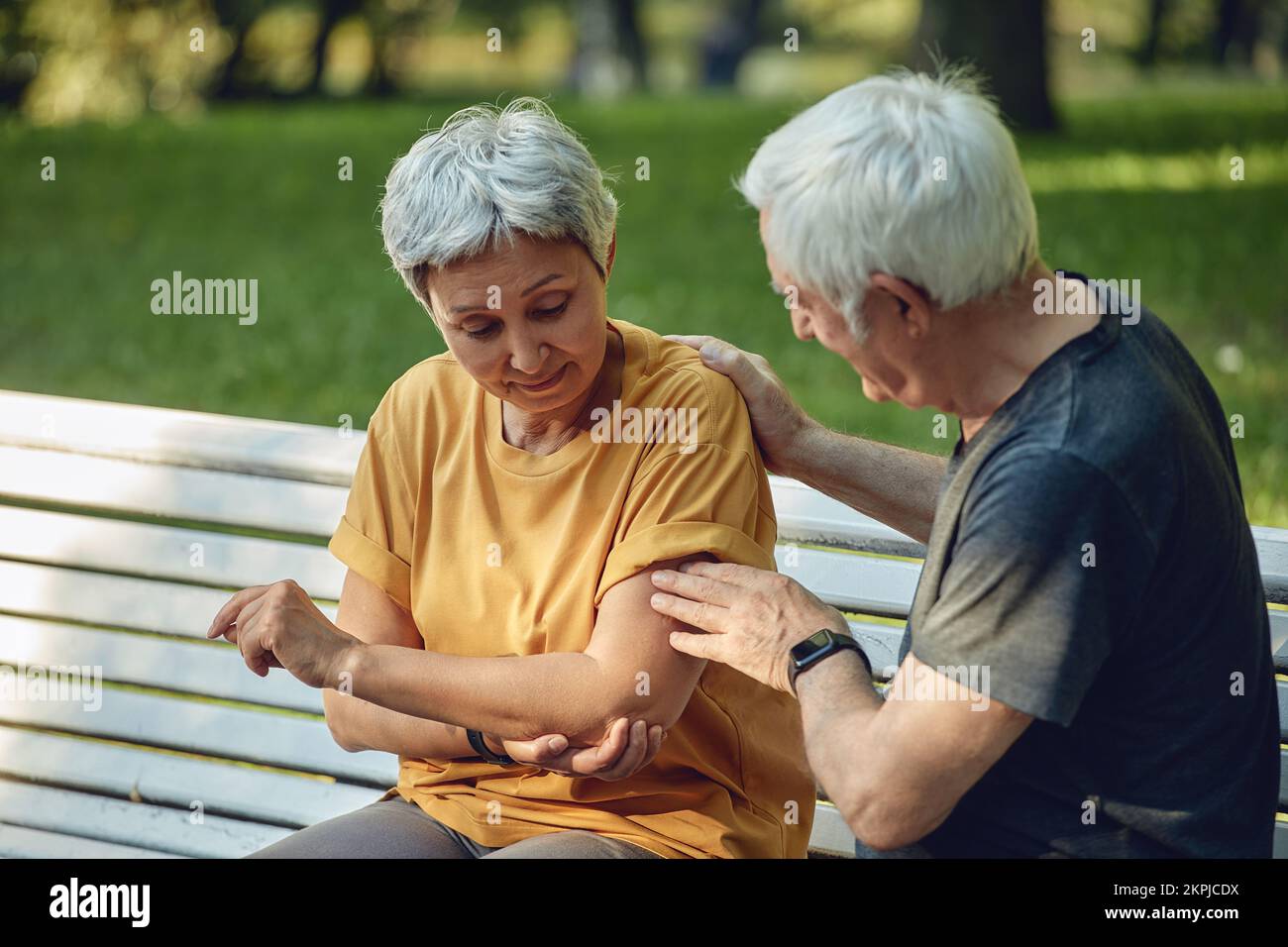 During morning sportive stroll or making exercises in park, old 60s