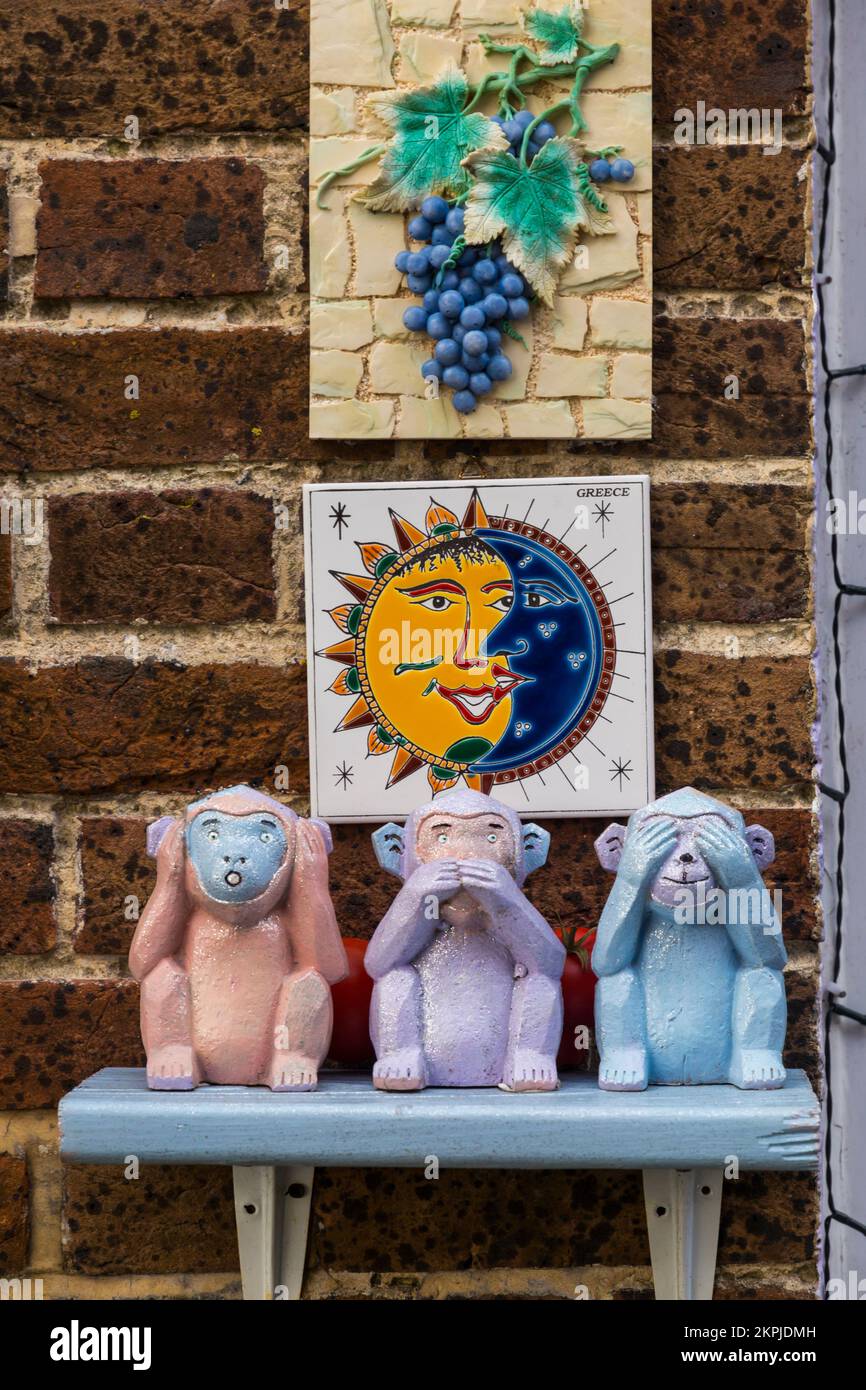 Hear no evil, speak no evil, see no evil monkeys ornaments at Weymouth, Dorset UK in October Stock Photo