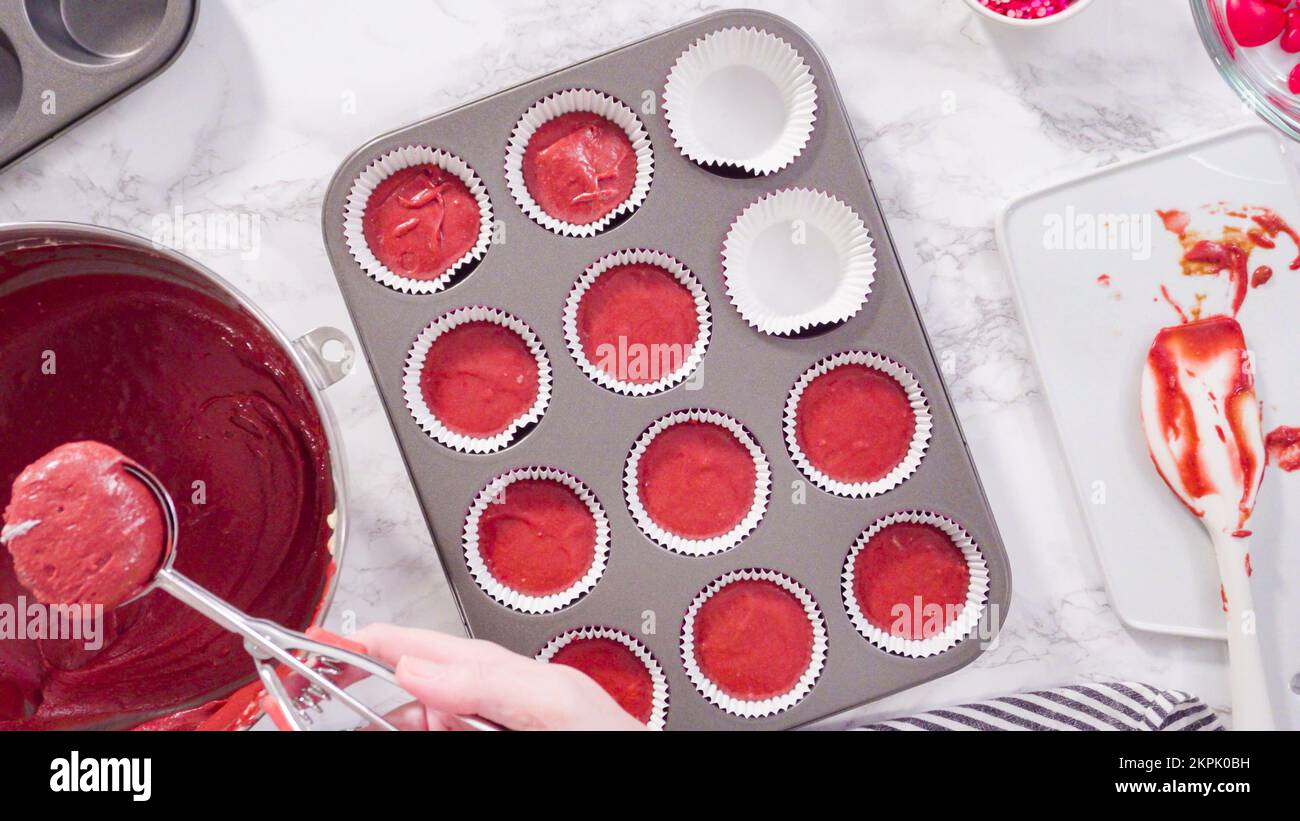 Step by step. Scooping batter with a cupcake scoop to make unicorn  chocolate cupcakes with buttercream frosting Stock Photo - Alamy