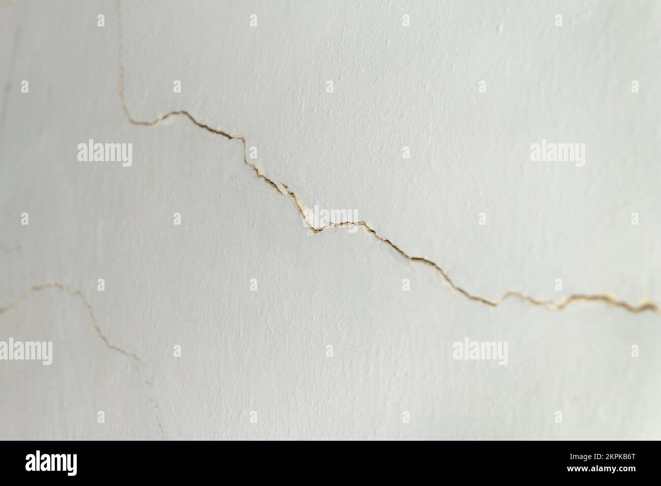 A wall that needs urgent repair. A lot of cracks have formed on old