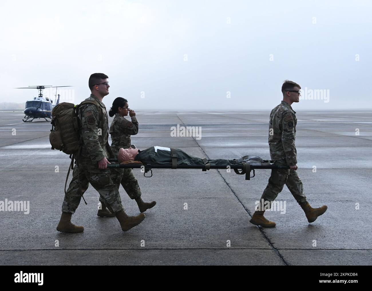 2nd Lt. Dylan Thomas, 316th Health Care Operations Squadron intensive care unit nurse (left), Capt. Dominique Hunsberger, 316th HCOS intensive care unit nurse (center), and Capt. Nicholas Lahvic, 316th Surgical Operations Squadron anesthesiologist, carry a simulation manikin during a medical training at Joint Base Andrews, Md., Nov. 1, 2022. Members of the 316th Wing Critical Care Air Transport Teams joined the 1st Helicopter Squadron for highly specialized medical training exercises. Stock Photo