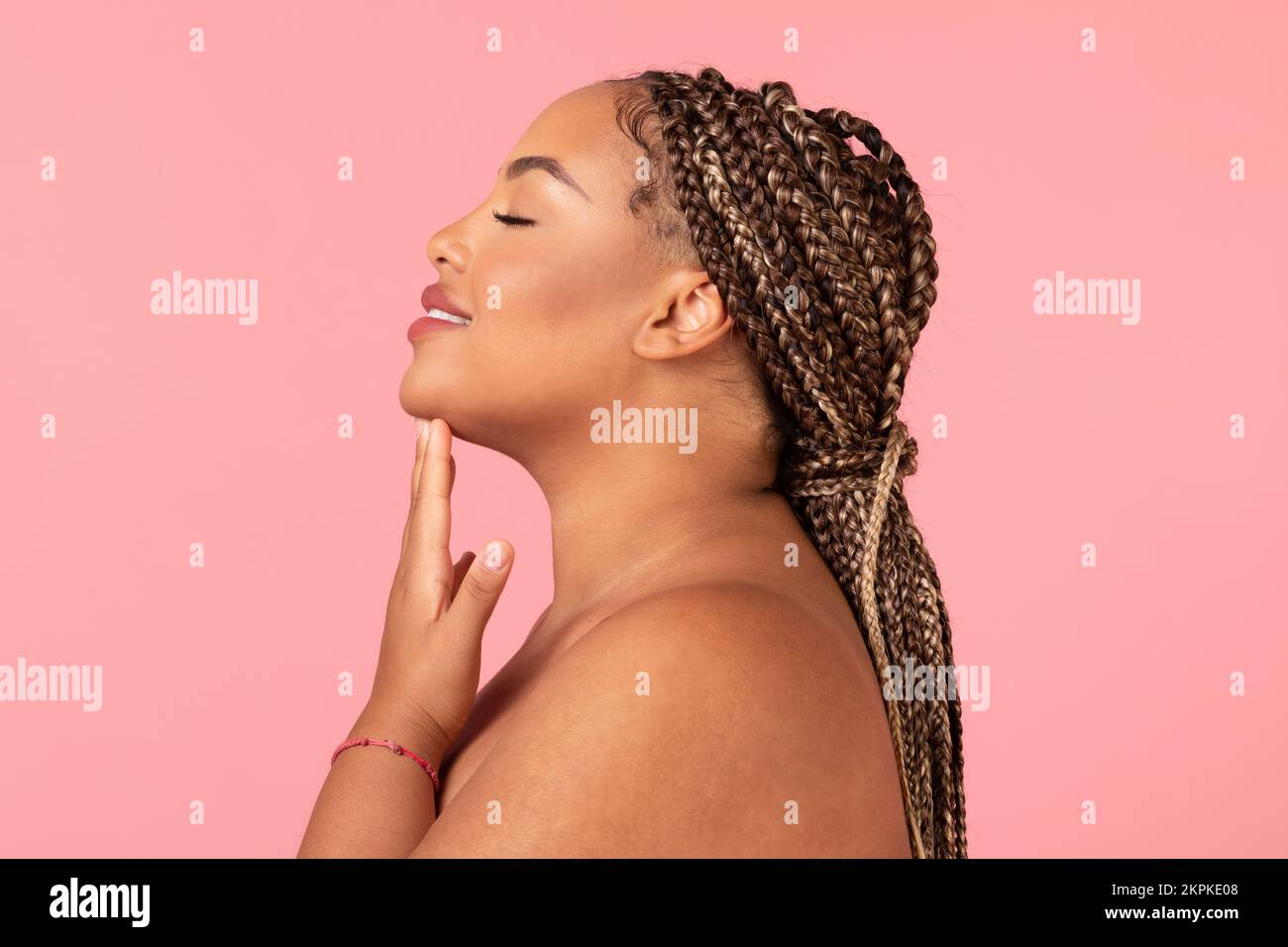 Facial treatment. Profile portrait of black obese woman with perfect
