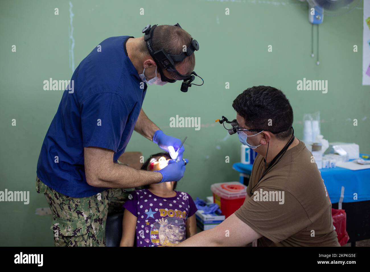 Navy Cmdr. Pete Cervenka, an oral and maxillofacial surgeon from Concord, California, and Lt. Kevin Campbell, a general dentist from Taunton, Massachusetts, perform dental care on a patient at a medical site in Tegucigalpita, Honduras during Continuing Promise 22, Nov. 1, 2022. CP22 is a humanitarian assistance and goodwill mission conducting direct medical care, expeditionary veterinary care, and subject matter expert exchanges with five partner nations in the Caribbean, Central and South America. Stock Photo