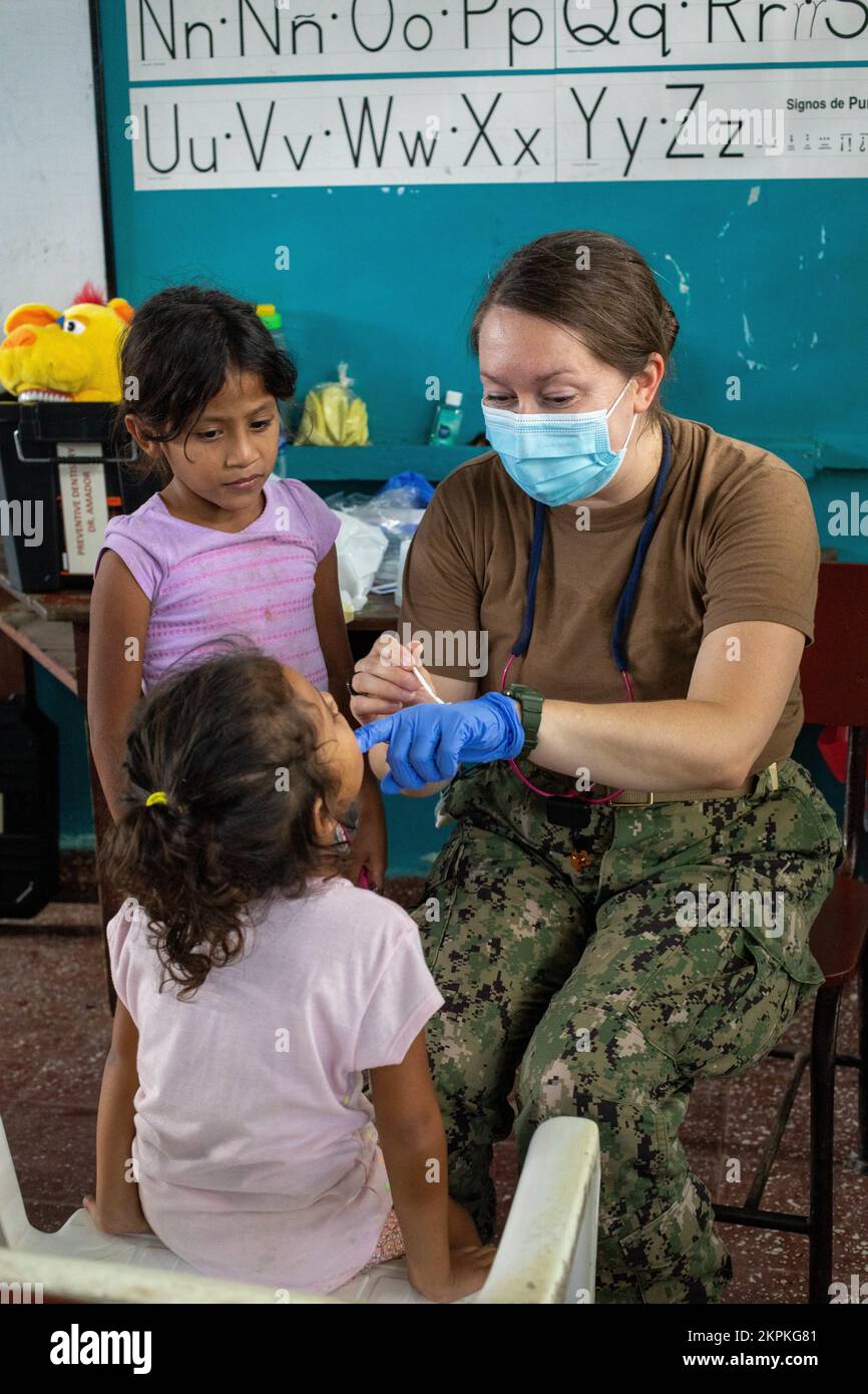 Navy Lt. Cmdr. Amie Heim, a pediatric dentist from Buffalo, New York, applies fluoride on a patient while performing dental care at a medical site in Tegucigalpita, Honduras during Continuing Promise 22, Nov. 1, 2022. CP22 is a humanitarian assistance and goodwill mission conducting direct medical care, expeditionary veterinary care, and subject matter expert exchanges with five partner nations in the Caribbean, Central and South America. Stock Photo