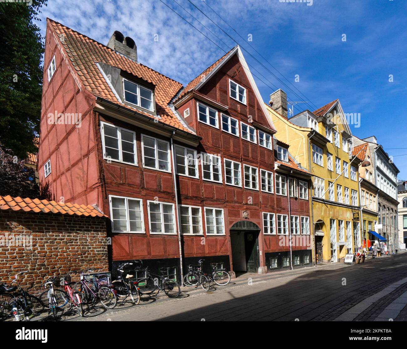 Bicycles parked outside colourful traditional colourful timber framed buildings, Copenhagen, Zealand, Denmark Stock Photo