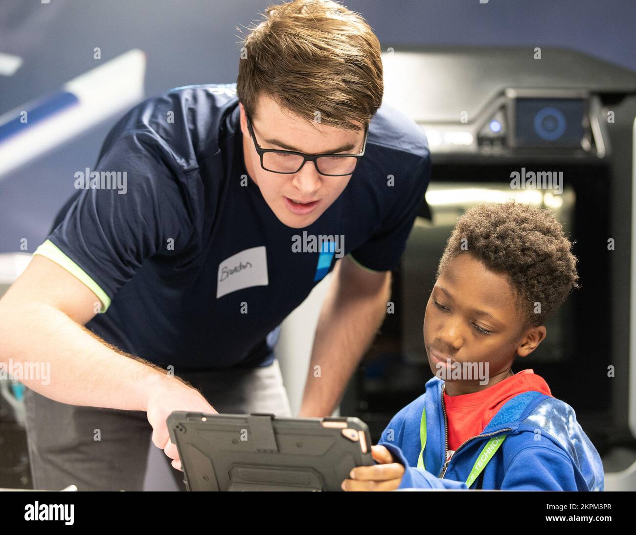 Brandon Stroick, a volunteer from the Medtronic Foundation helps a student from STARBASE Minnesota map out their Ozobots route in St. Paul, Nov. 1, 2022. The Minnesota Vikings and Medtronic volunteered their time to learn science, technology, engineering, and mathematics (STEM) from STARBASE Minnesota students. STARBASE Minnesota is a Department of Defense educational program that immerses students in real-world STEM throughout the school year and summer. Stock Photo