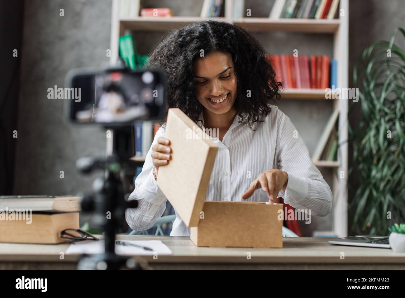 Beautiful young multinational woman recording video on camera while ...