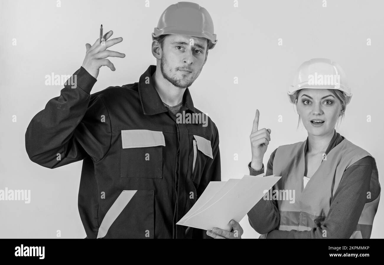 Solving problems concept. Man and woman in hard hats Stock Photo - Alamy