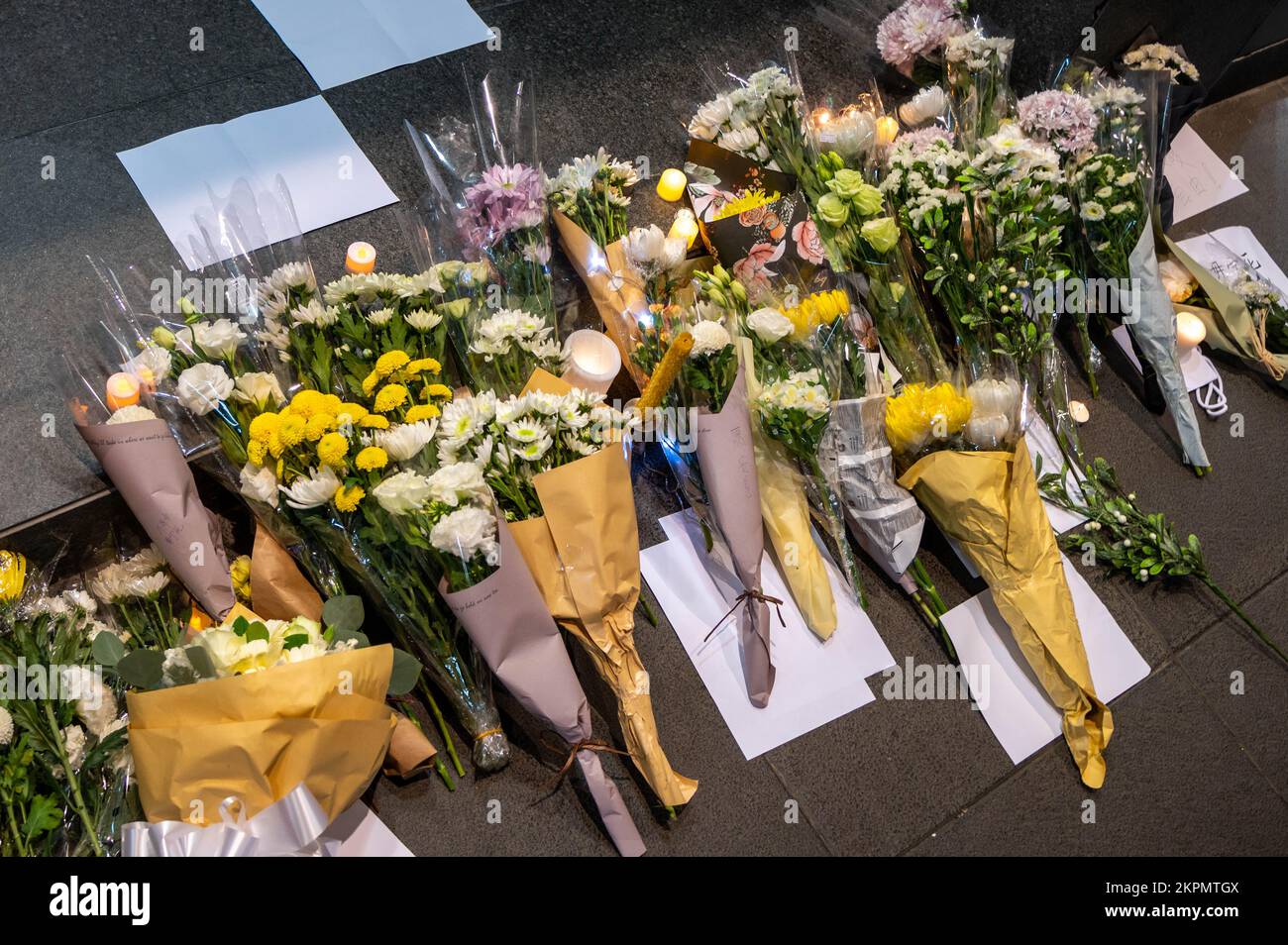 Hong Kong. 28th Nov, 2022. Memorial flowers and blank pieces of paper left on the ground during a demonstration. Dozens gathered in solidarity with those in China rallying against the government's zero-COVID policies. Shortly after chanting 'do not want authoritarianism, do not want a monarchy,' Wong was attacked by an assailant and knocked to the ground. (Photo by Ben Marans/SOPA Images/Sipa USA) Credit: Sipa USA/Alamy Live News Stock Photo