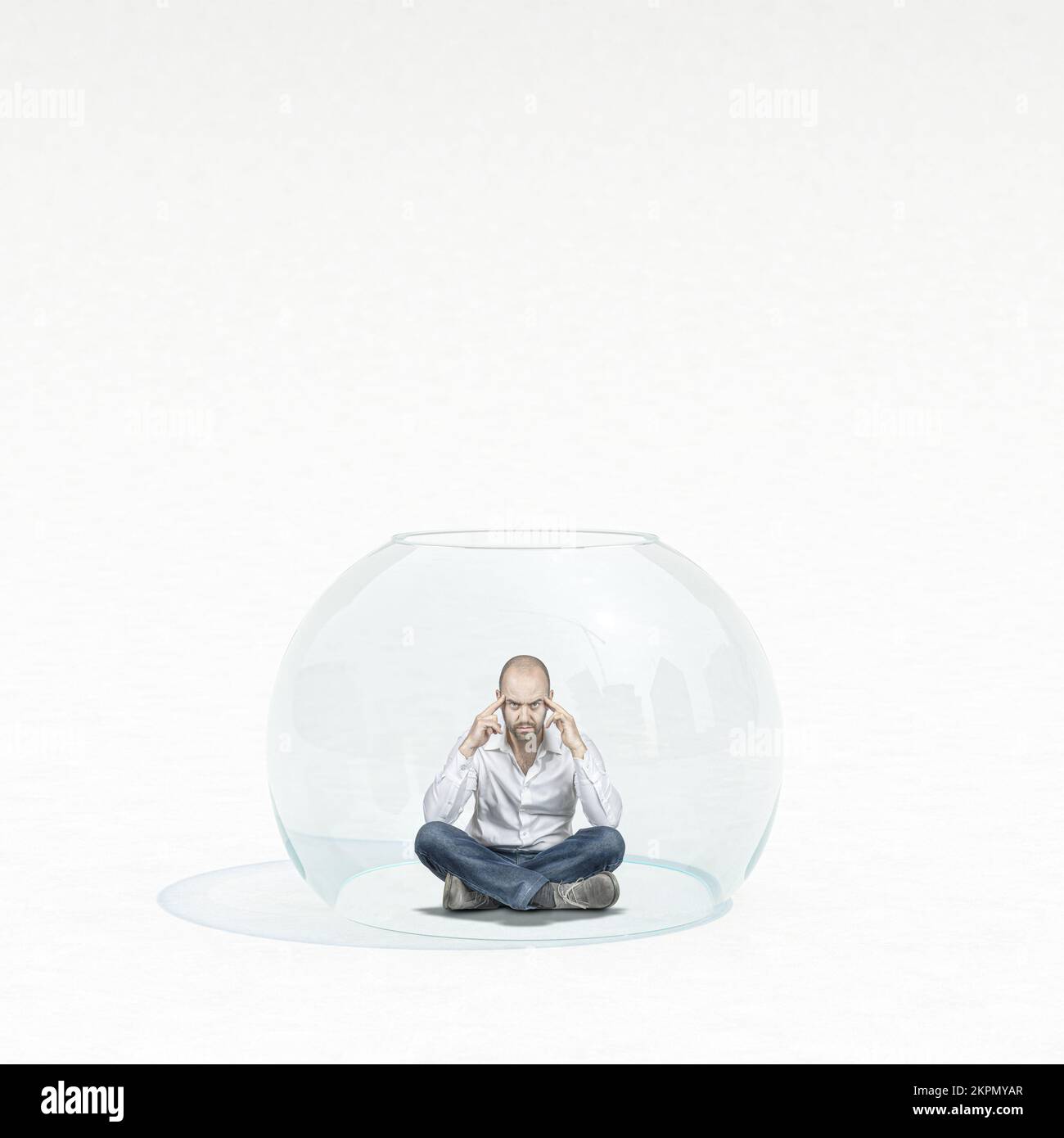 pensive man sitting inside a glass bubble Stock Photo