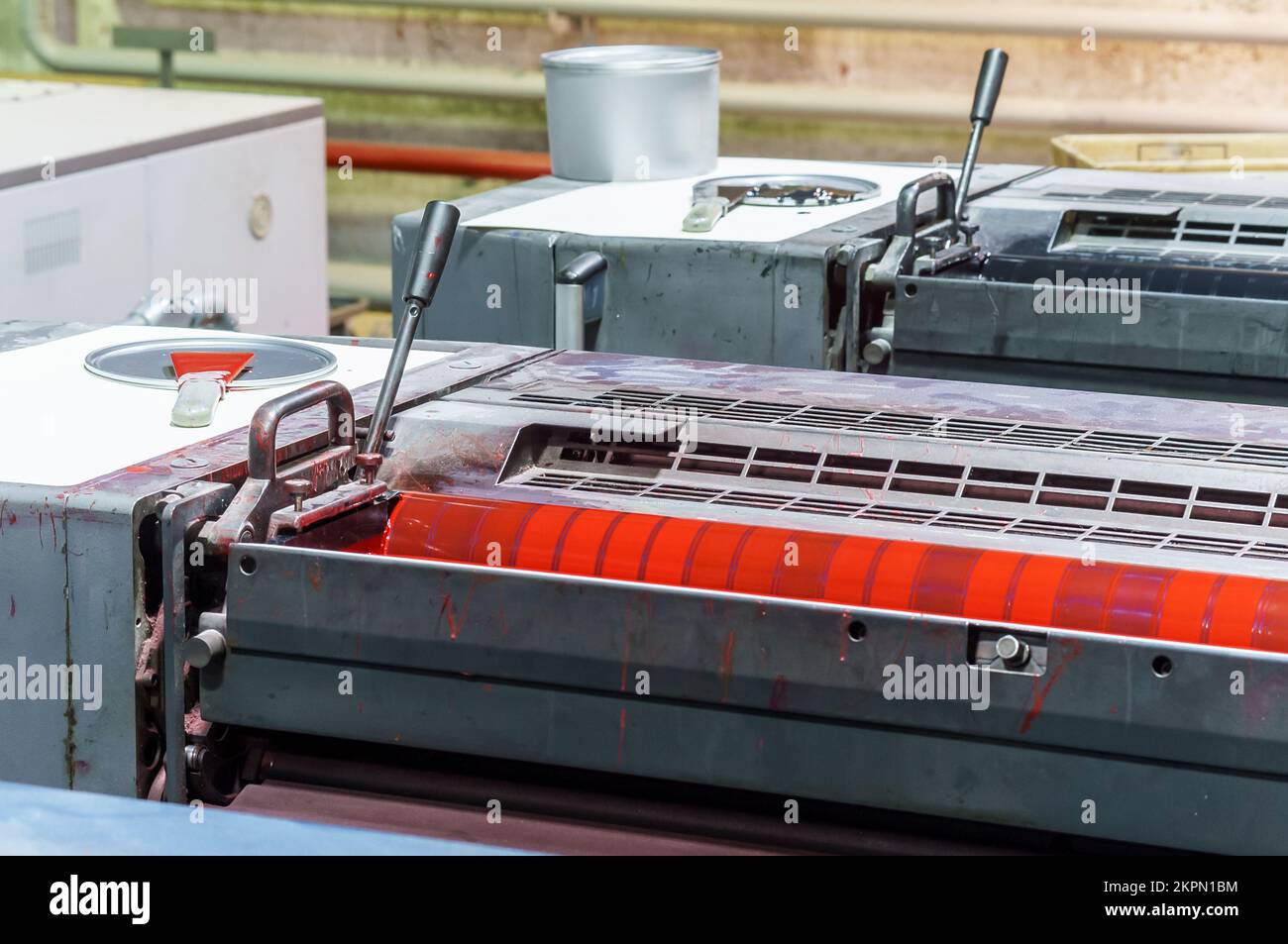 Red magenta ink in the printing press. Section of the printing press