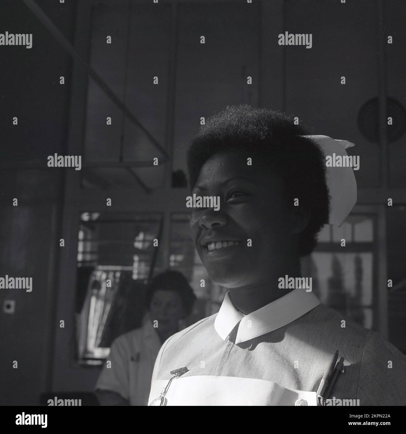 1969, historical, young female NHS nurse of Caribbean descent on a hospital ward at Warwick Hospital, England, UK. Stock Photo