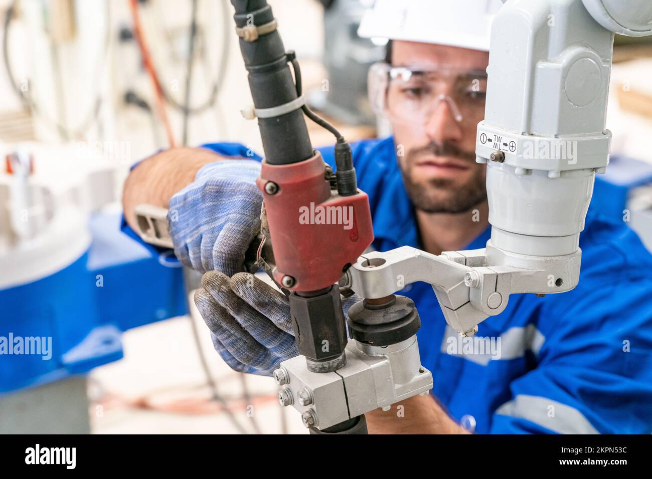 Robotics engineer working on maintenance of modern robotic arm in
