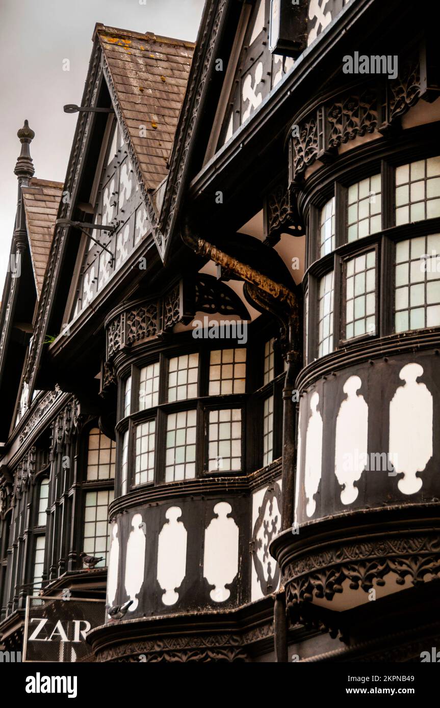 Bow windows and steep pediments of Black-and-white Revival timber frame in the English town of Chester. Stock Photo