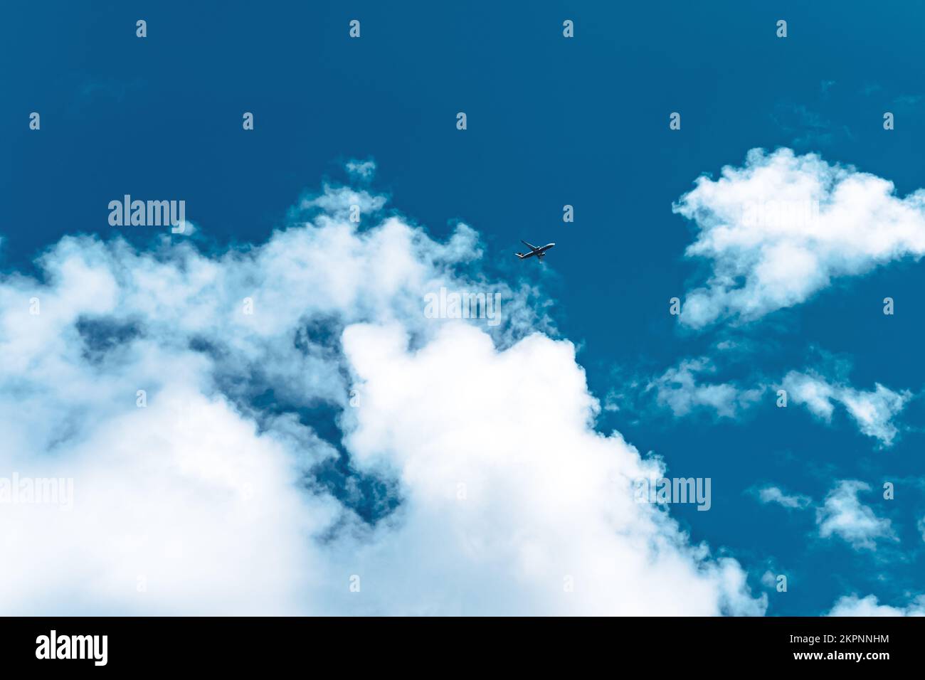 Description Airplane flying through clouds photogrpahed from below