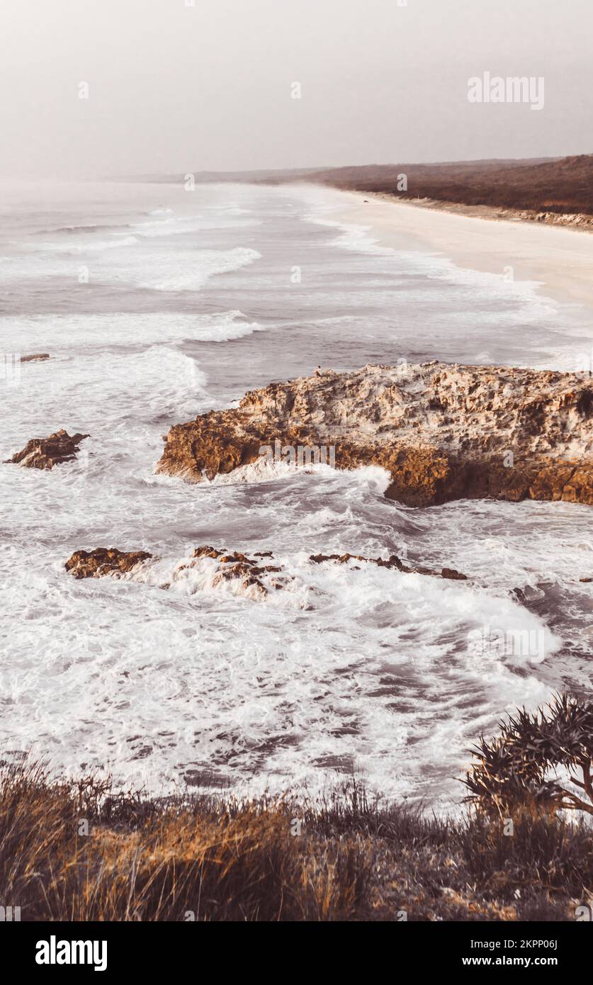 Dramatic coastal photograph with wave breaks on early morning shores. Captured: Main Beach, North Stradbroke Island, Queensland, Australia Stock Photo