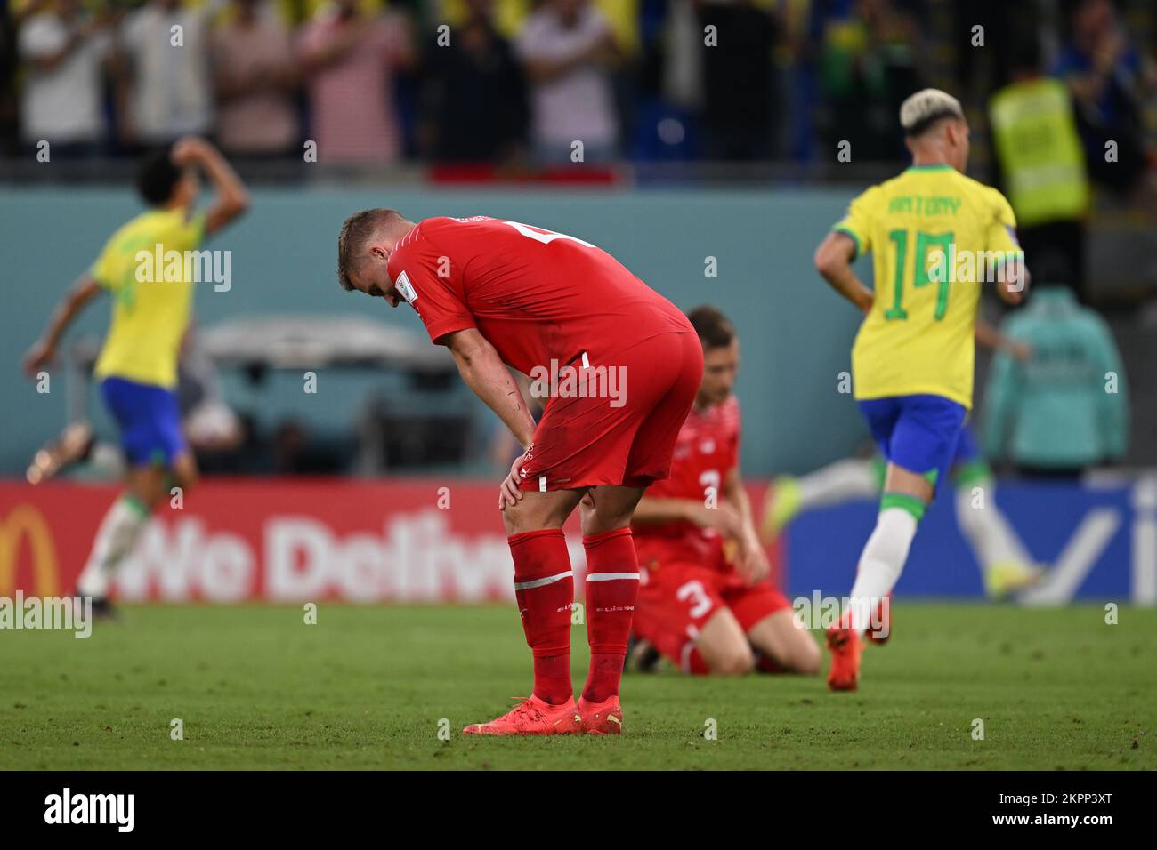 Doha, Qatar. 28th Nov, 2022. Soccer, World Cup 2022 in Qatar, Brazil - Switzerland, Preliminary Round, Group G, Matchday 2, at Stadium 974, Nico Elvedi of Switzerland props himself up after conceding a goal while Brazil's players turn away in jubilation. Credit: Federico Gambarini/dpa/Alamy Live News Credit: dpa picture alliance/Alamy Live News Stock Photo