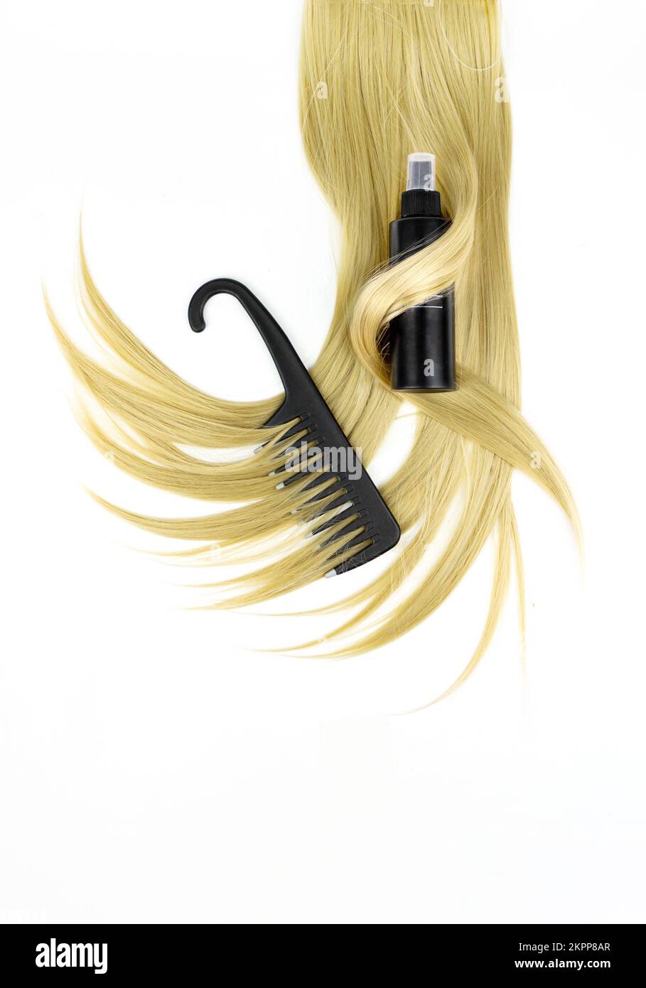 Different professional hairdresser tools black hairbrush with hair spray and strand of blonde hair on white background, flat lay. Hair care spa concep Stock Photo