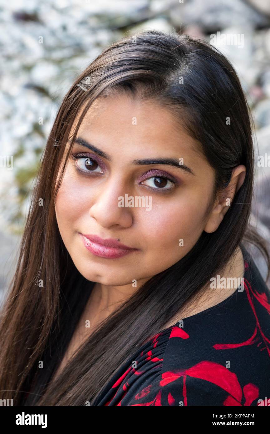 Pretty dark-haired woman gazing up into the camera Stock Photo