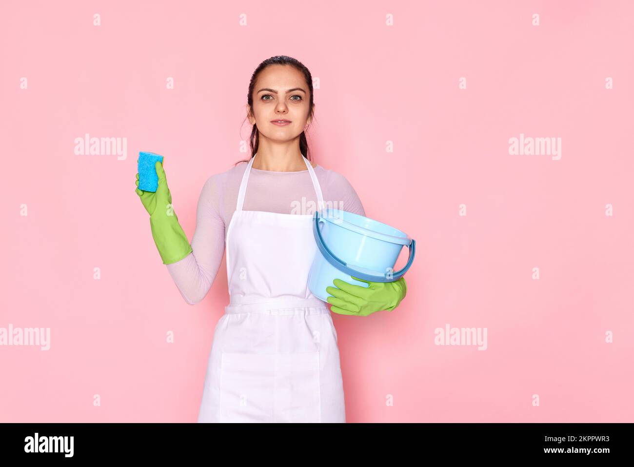 woman in gloves and cleaner apron cleaning with yellow sponge Stock ...