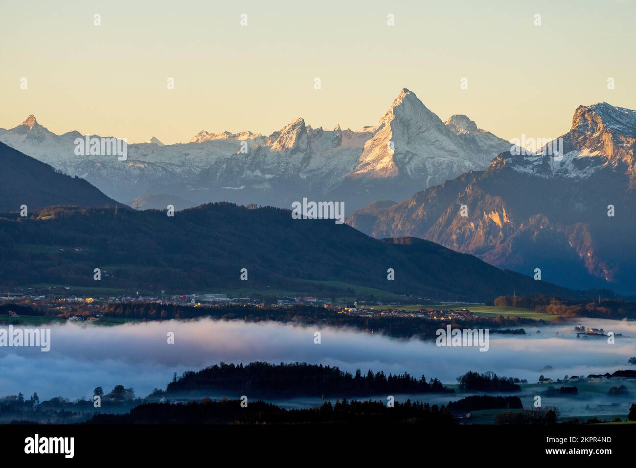 Low clouds over forest landscape with Mt Watzmann at dawn, Salzburg, Austria Stock Photo