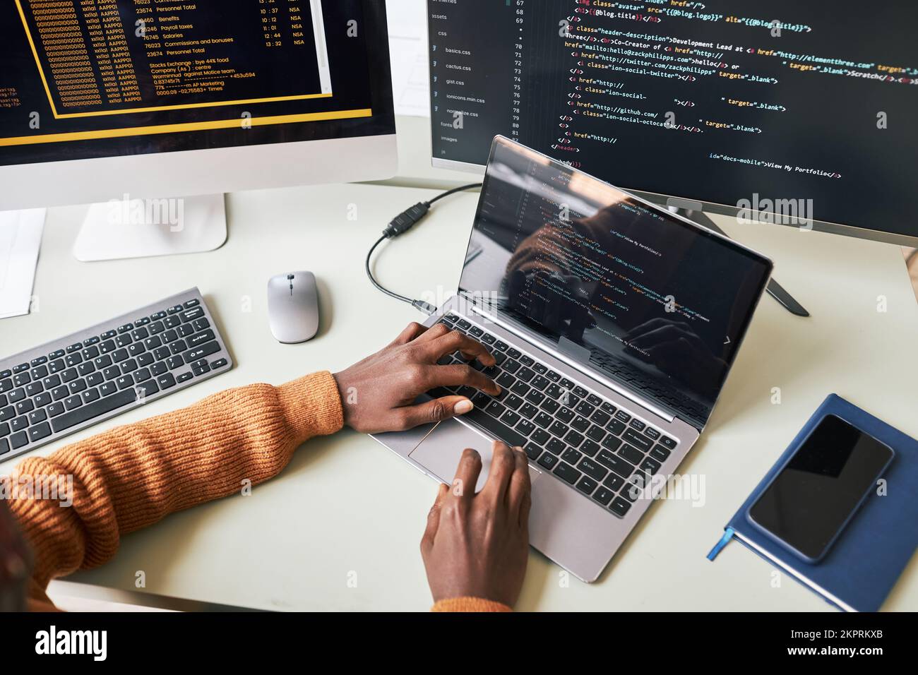 Hands of young man testing programming code for new application on laptop Stock Photo