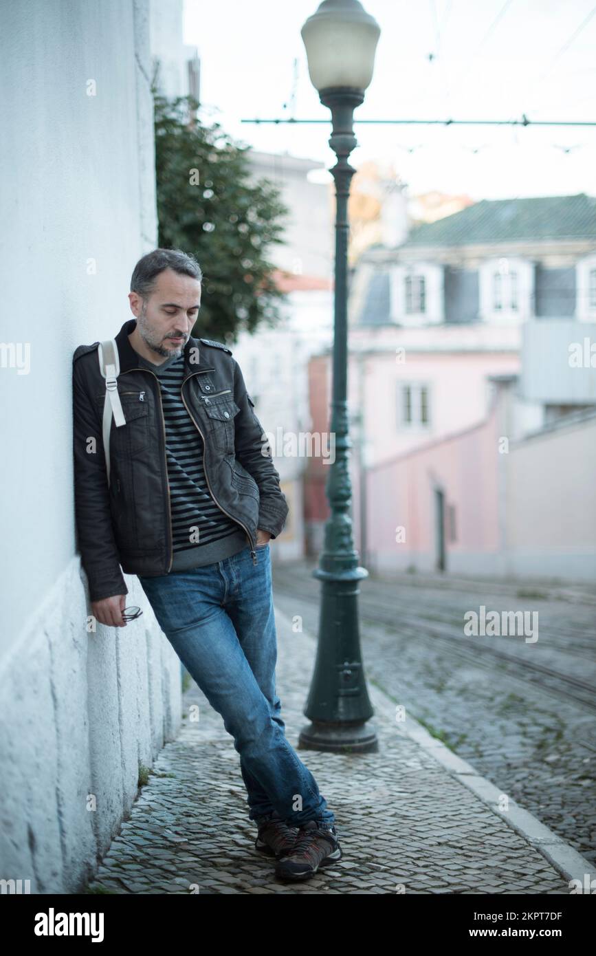 Tired man leaning wall hi-res stock photography and images - Alamy