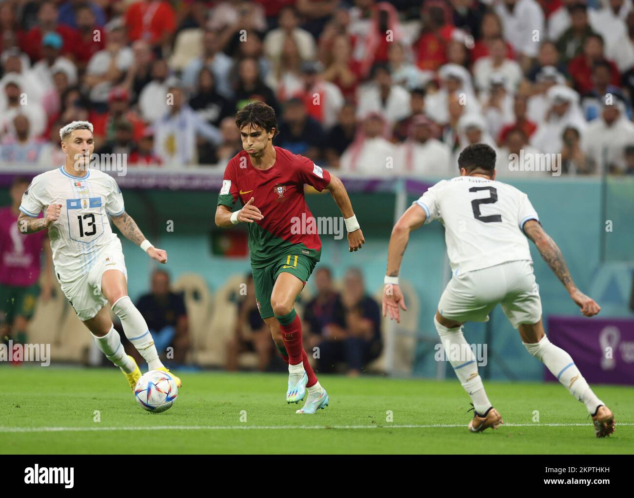 Lusail, Qatar. 28th Nov, 2022. Guillermo Varela (L) and Jose Maria Gimenez (R) of Uruguay vies with Joao Felix of Portugal during the Group H match between Portugal and Uruguay at the 2022 FIFA World Cup at Lusail Stadium in Lusail, Qatar, Nov. 28, 2022. Credit: Pan Yulong/Xinhua/Alamy Live News Stock Photo