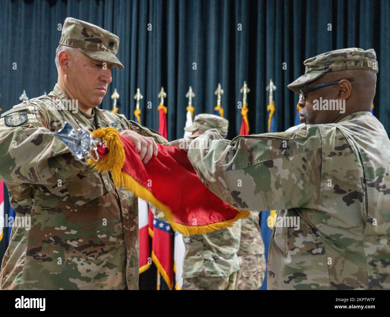 U.S. Army Lt. Col. Rene Martinez, commander of the 36th Special Troops Battalion and Command Sgt. Maj. Charles Bouyer, senior enlisted advisor to Martinez, case their battalion’s flag during a transfer of authority ceremony, Nov. 3, 2022, at Camp Arifjan, Kuwait. The transfer of authority ceremony signifies the end of the responsibilities of Task Force Phoenix followed by the assumption of responsibility by Task Force Hellfighter. Stock Photo