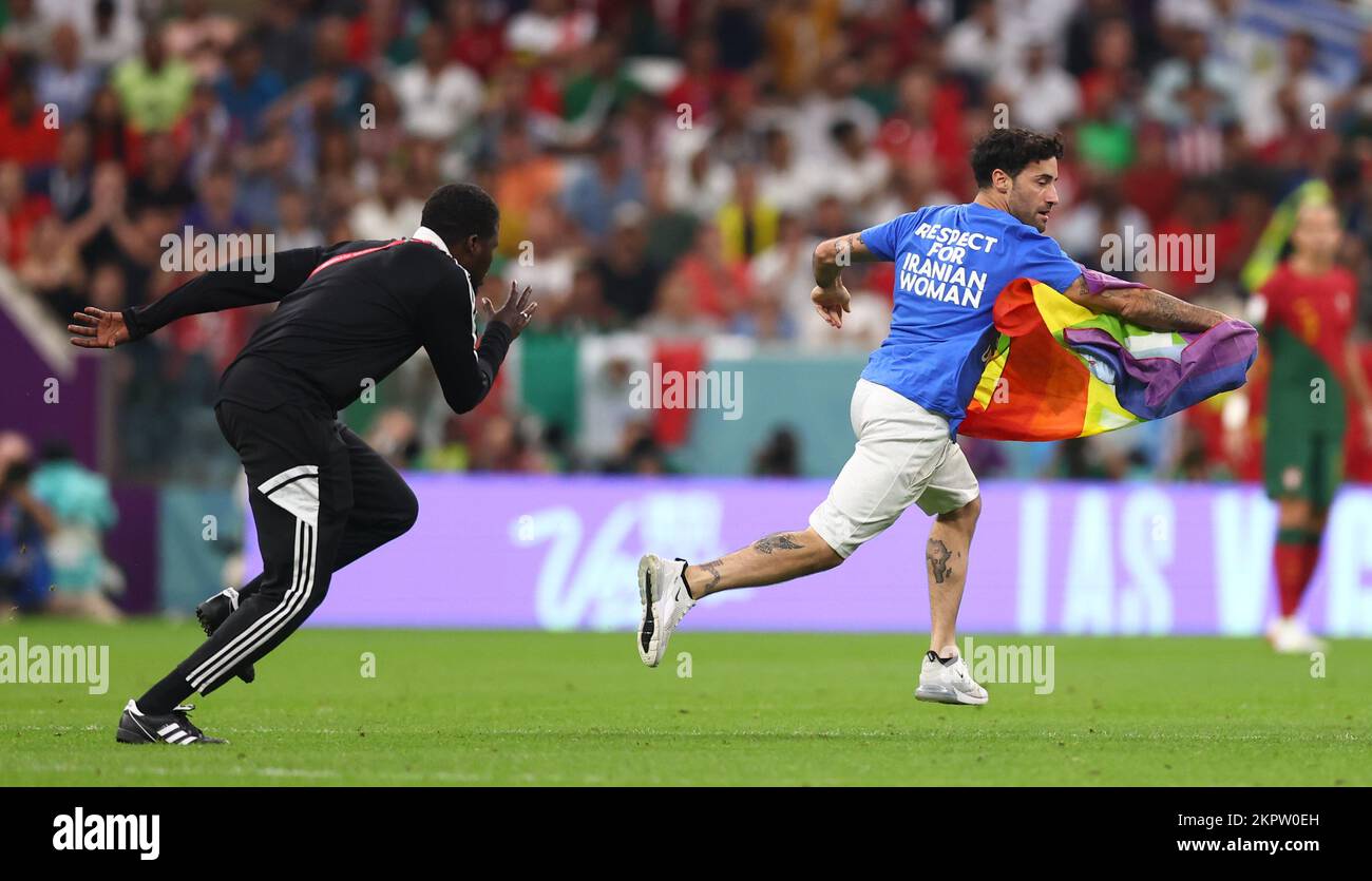 Doha, Qatar. 28th Nov, 2022. A pitch invader runs on with a rainbow flag and a t-shirt saying “Respect for Iranian Woman” during the FIFA World Cup 2022 match at Lusail Stadium, Doha. Picture credit should read: David Klein/Sportimage Credit: Sportimage/Alamy Live News Stock Photo