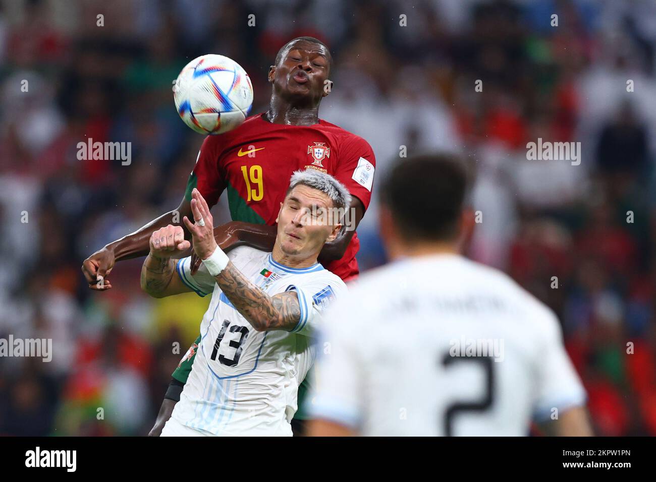 Lusail, Qatar. 28th Nov, 2022. Soccer, World Cup 2022 in Qatar, Portugal - Uruguay, Preliminary Round, Group H, Matchday 2, Lusail Stadium, Portugal's Nuno Mendes (back) fights for the ball with Uruguay's Guillermo Varela. Credit: Tom Weller/dpa/Alamy Live News Stock Photo