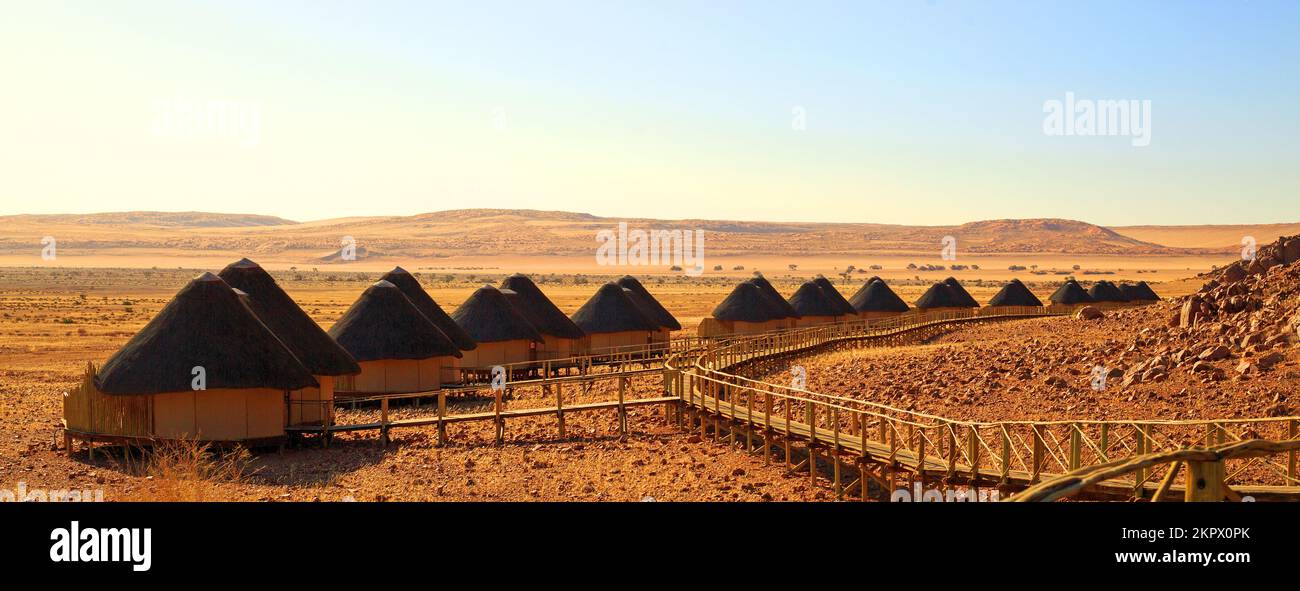 Souss Dune Lodge, Namibia, 2022.  Luxury accommodation in the desert, with thatched rondavels reached by wooden walkway with amazing views. This is th Stock Photo