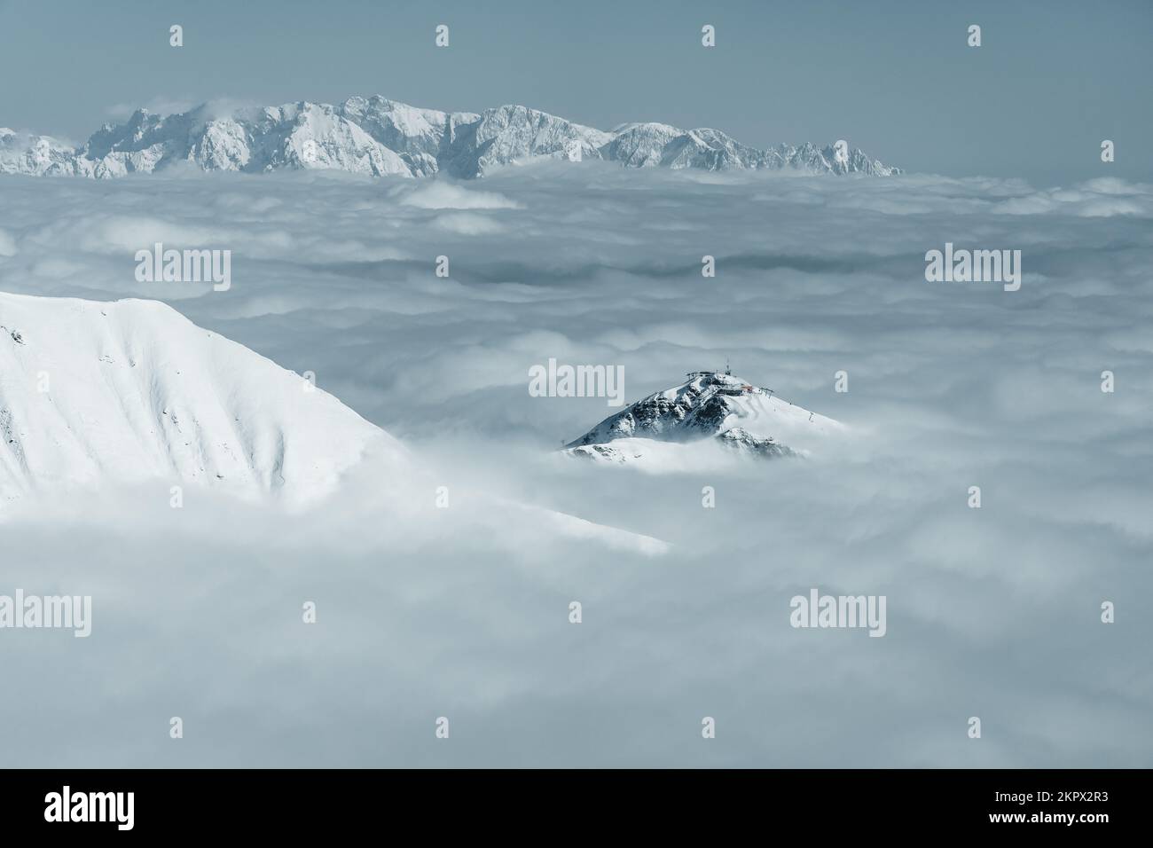 Snow covered mountain peaks through the clouds in Austrian Alps, Gastein, Salzburg, Austria Stock Photo