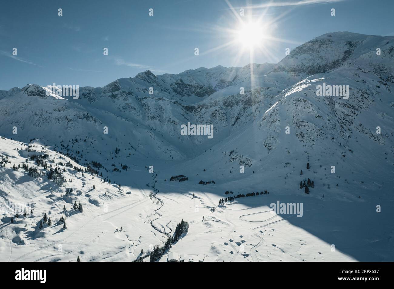 Aerial view of sunburst over cross country ski tracks in mountains, Sportgastein, Salzburg, Austria Stock Photo