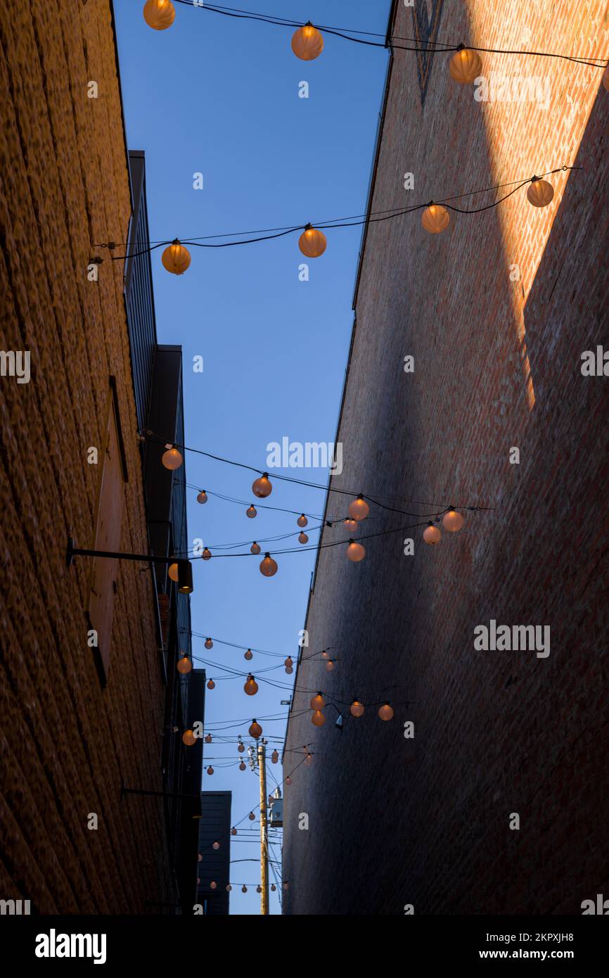 Sunset in the alley of old brick buildings backyard, power lines