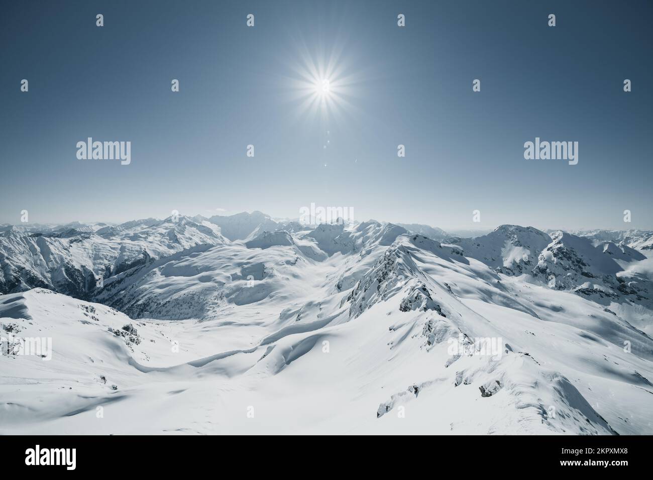 Sunburst over snowcapped mountains in Austrian Alps, Gastein, Salzburg, Austria Stock Photo