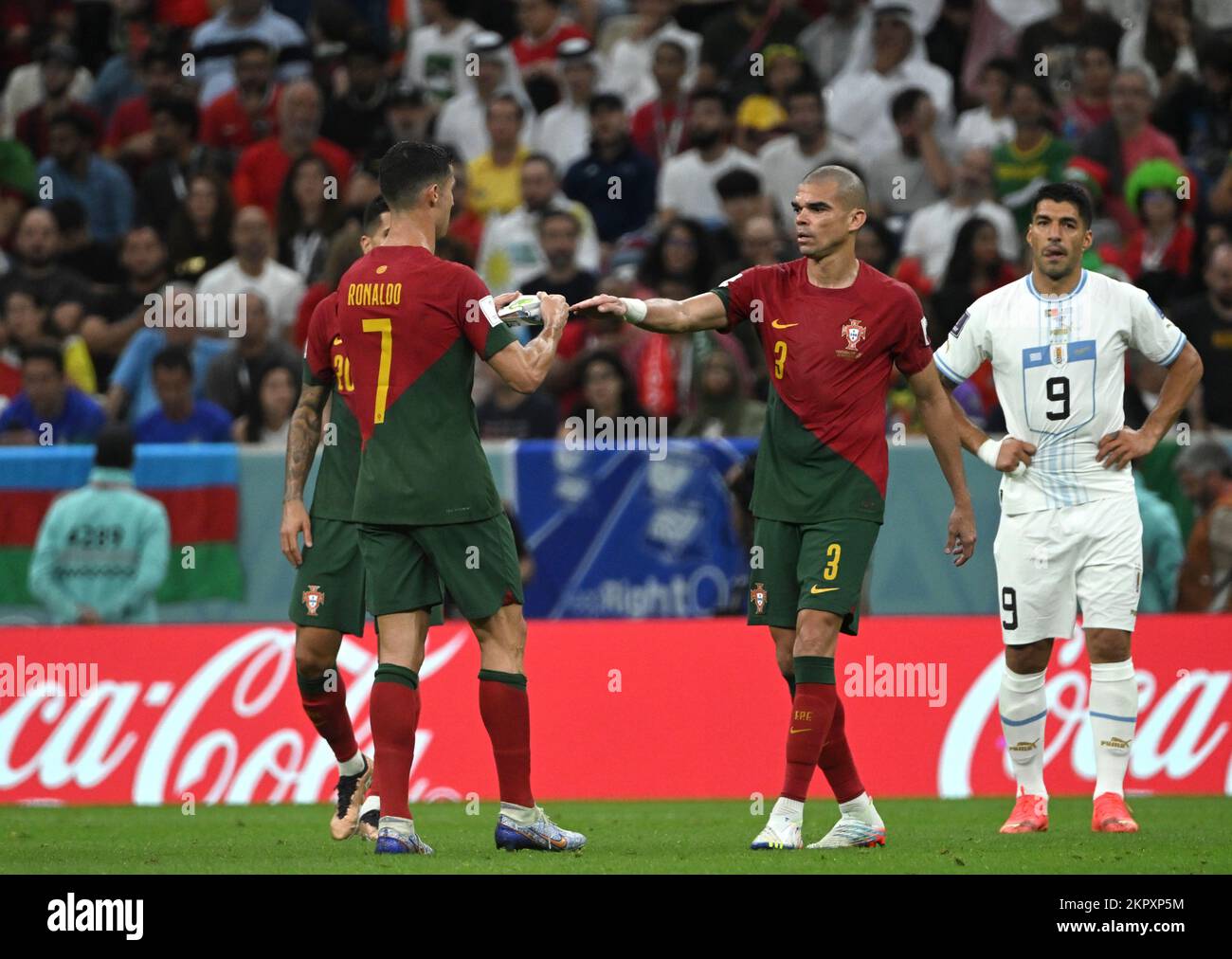 Lusail, Qatar. 28th Nov, 2022. Portugal's Cristiano Ronaldo (L, front) gives the captain armband to Portugal's Pepe (C) during the Group H match between Portugal and Uruguay at the 2022 FIFA World Cup at Lusail Stadium in Lusail, Qatar, Nov. 28, 2022. Credit: Li Ga/Xinhua/Alamy Live News Stock Photo