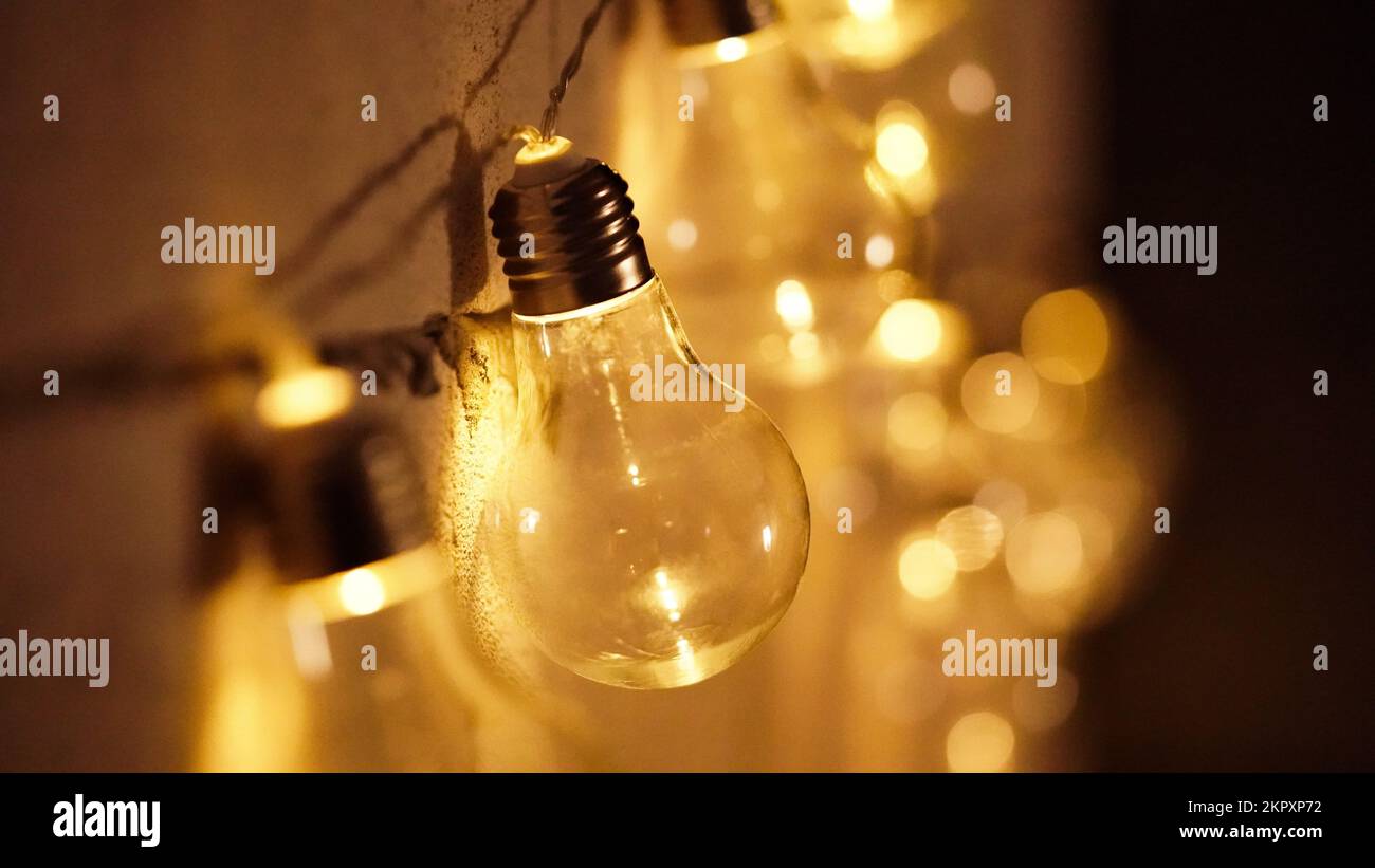 Glowing yellow light bulbs realistic photo depiction of turning