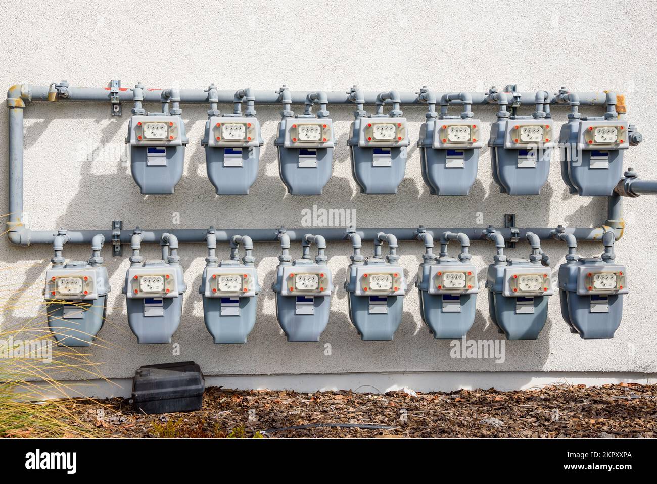 Rows of gas meters on the external wall of an apartment building Stock Photo
