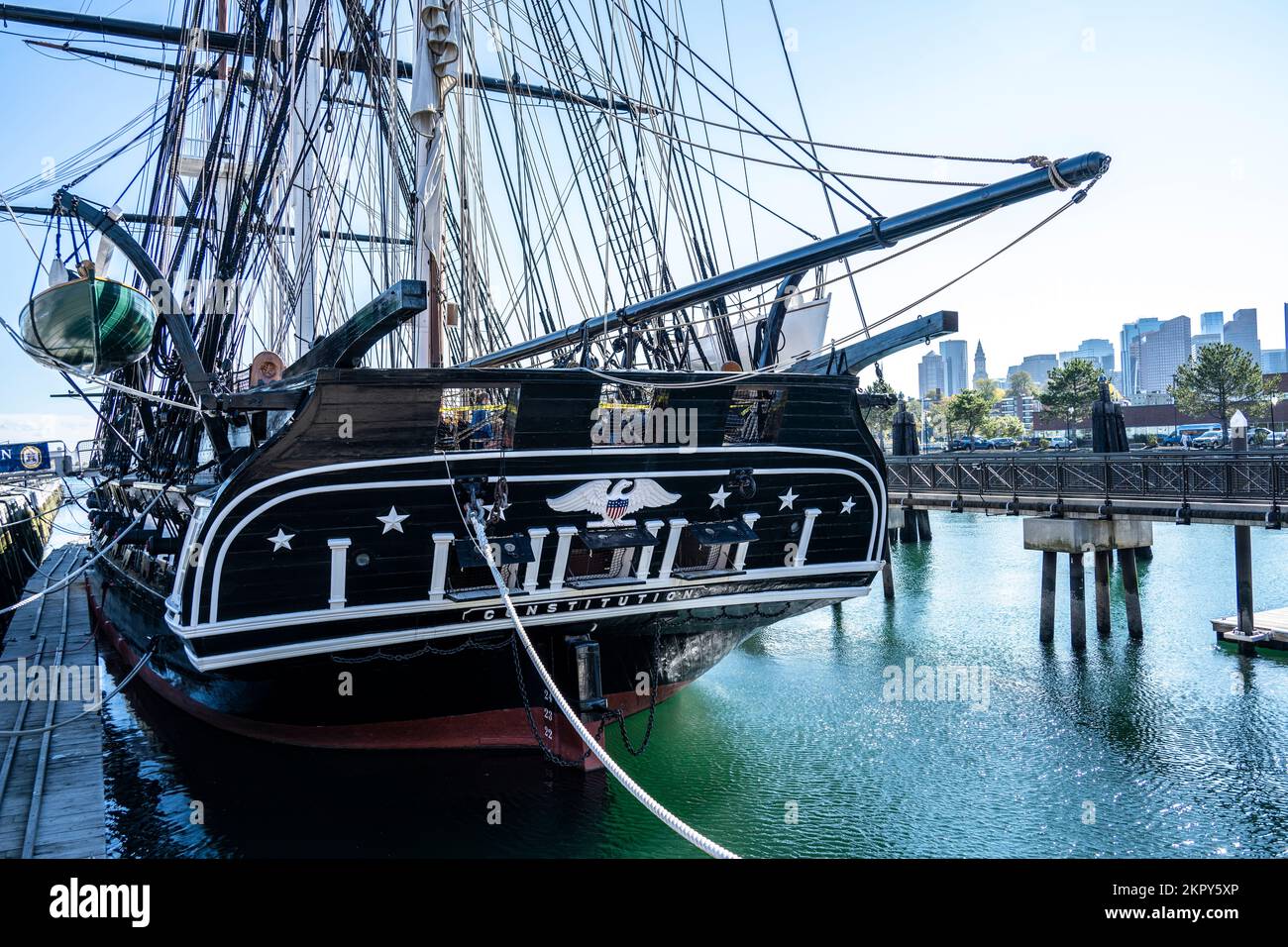 stern and port side of the USS Constitution with Boston skyline in the distance Stock Photo