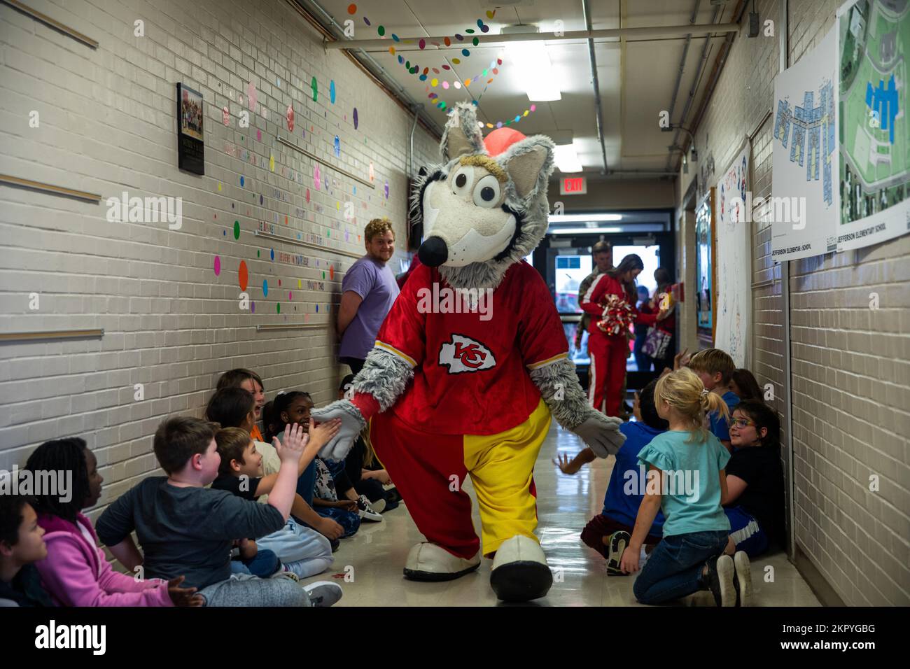 KC Wolf, the Kansas City Chiefs mascot, walks down the halls of Morris Hill Elementary giving out high fives to students on Fort Riley, Kansas, Nov. 4, 2022. KC Wolf visited schools on Fort Riley for the first time and gave away flag football kits to assist in providing students with an introduction to the sport of football. Stock Photo