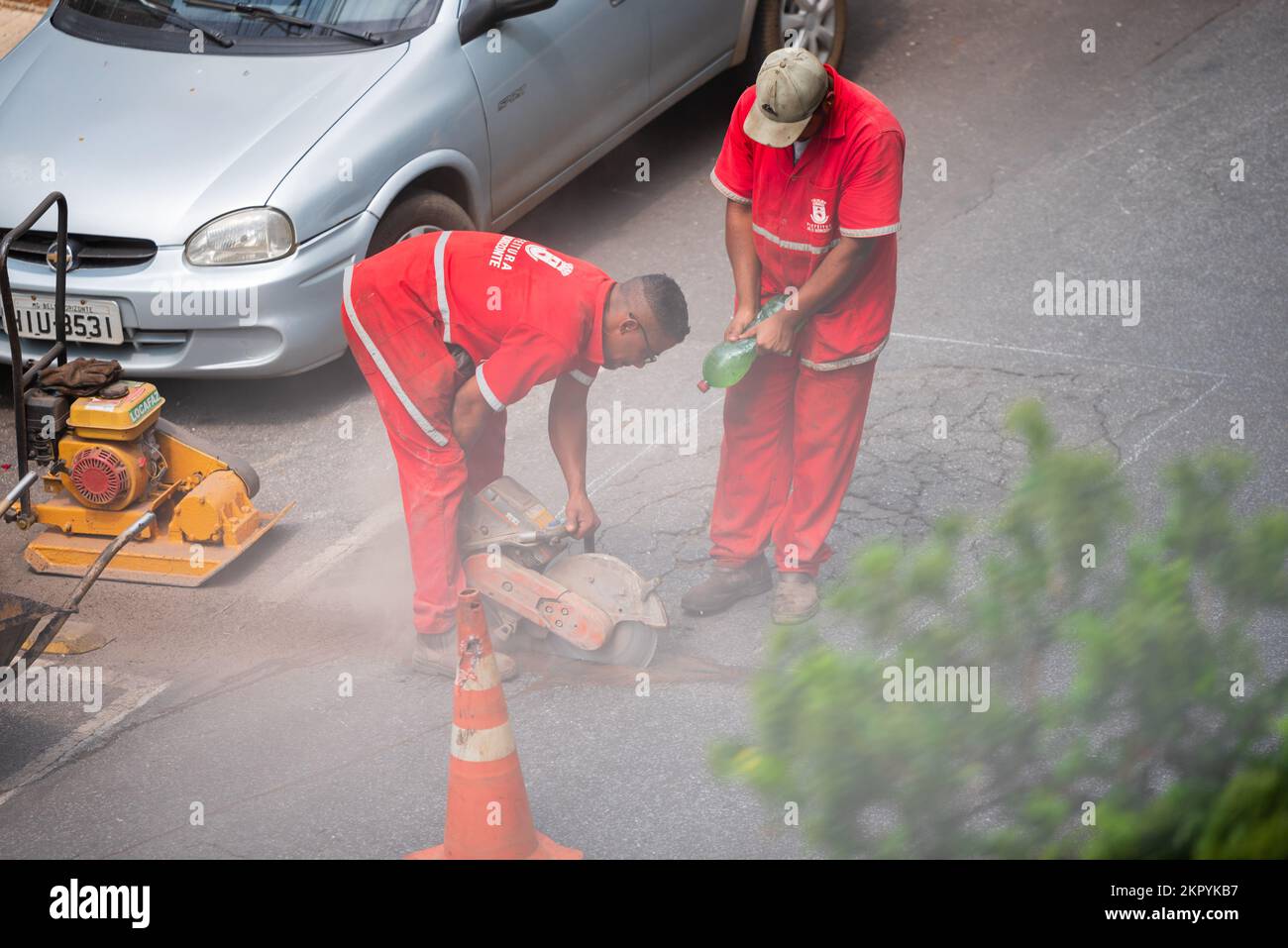 City of Belo Horizonte workers repairing a road with asphalt cutter at Gutierrez in Belo Horizonte, Minas Gerais, Brazil. Stock Photo